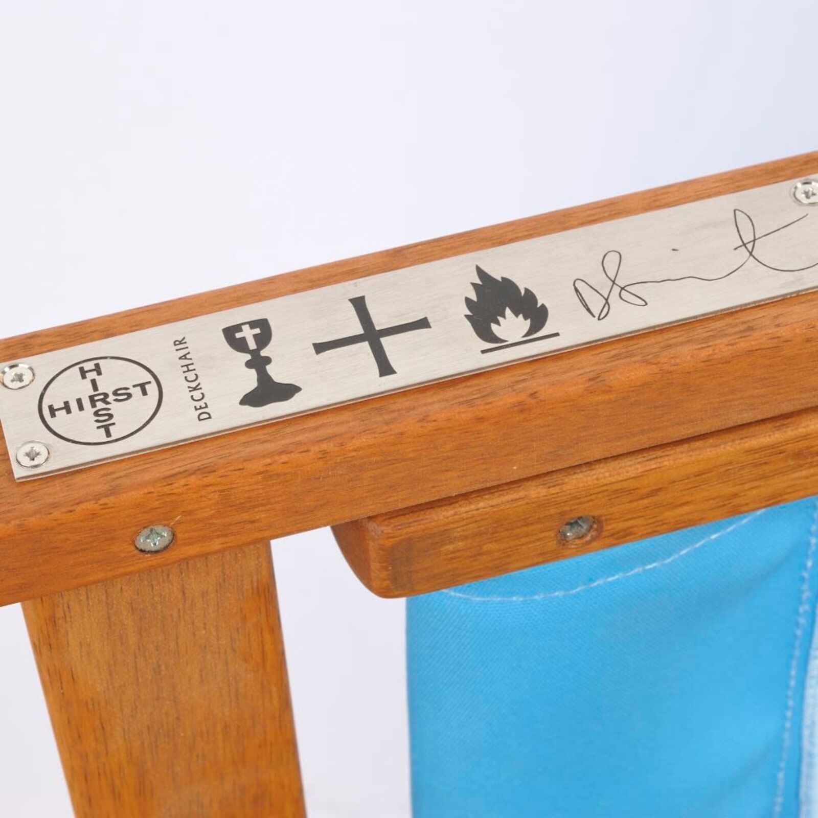 A wooden deck chair with a blue butterfly print on it.