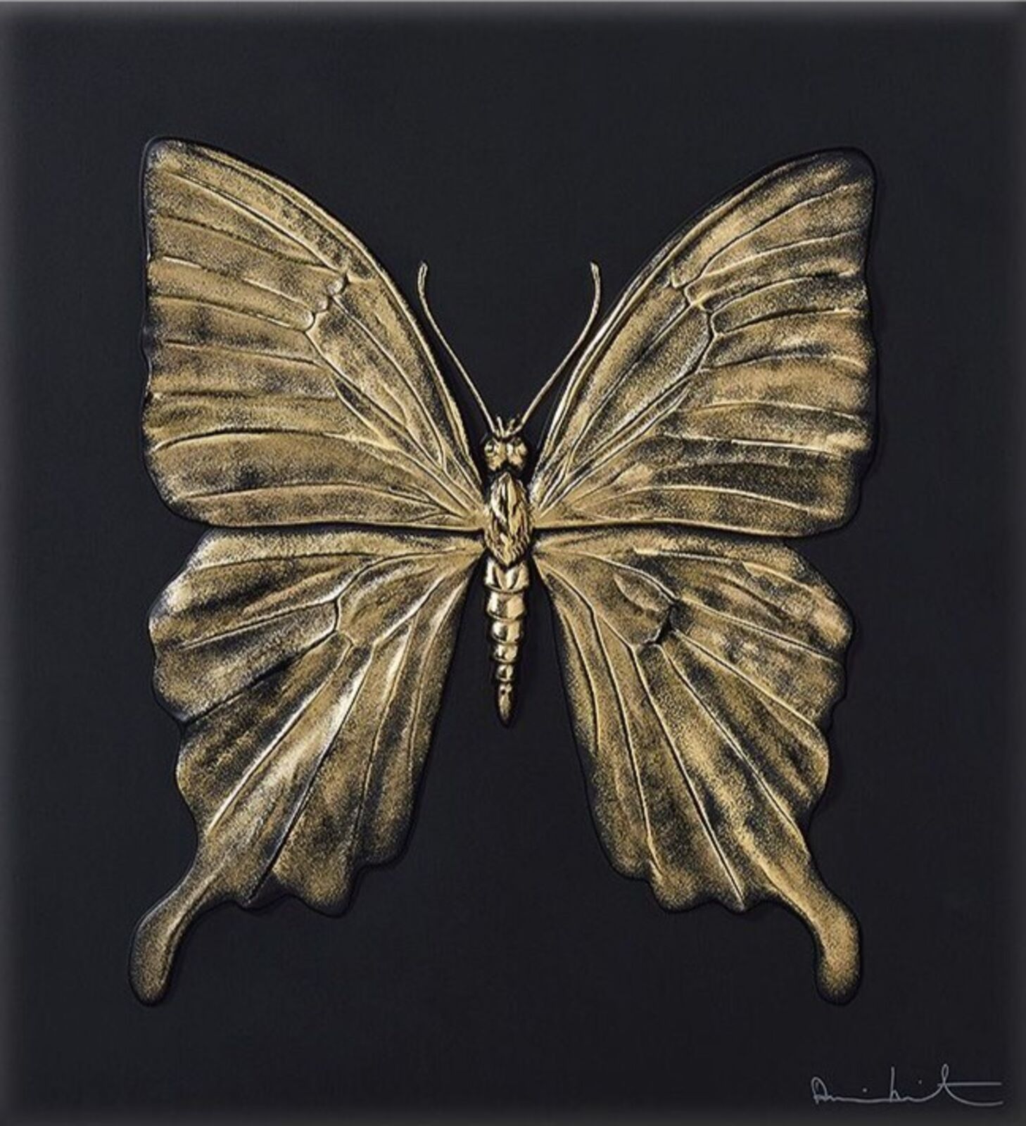 A gold butterfly on a black background. 