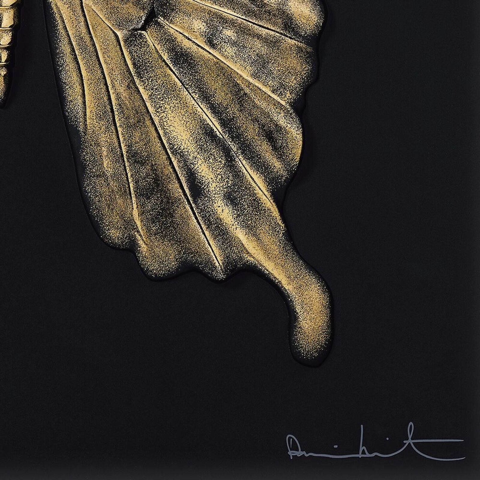 A gold butterfly on a black background. 