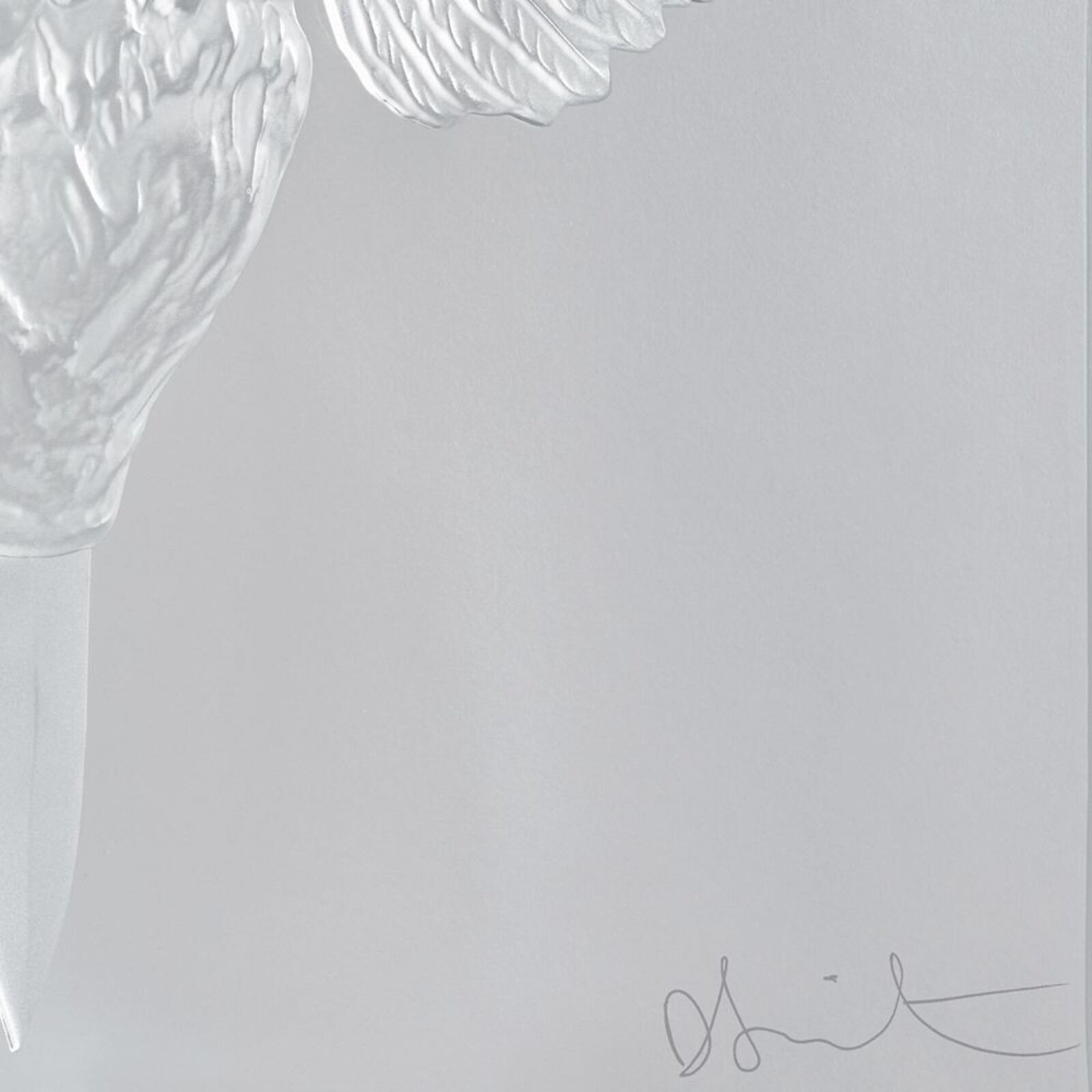 A glass sculpture of an angel with a sword in its beak.