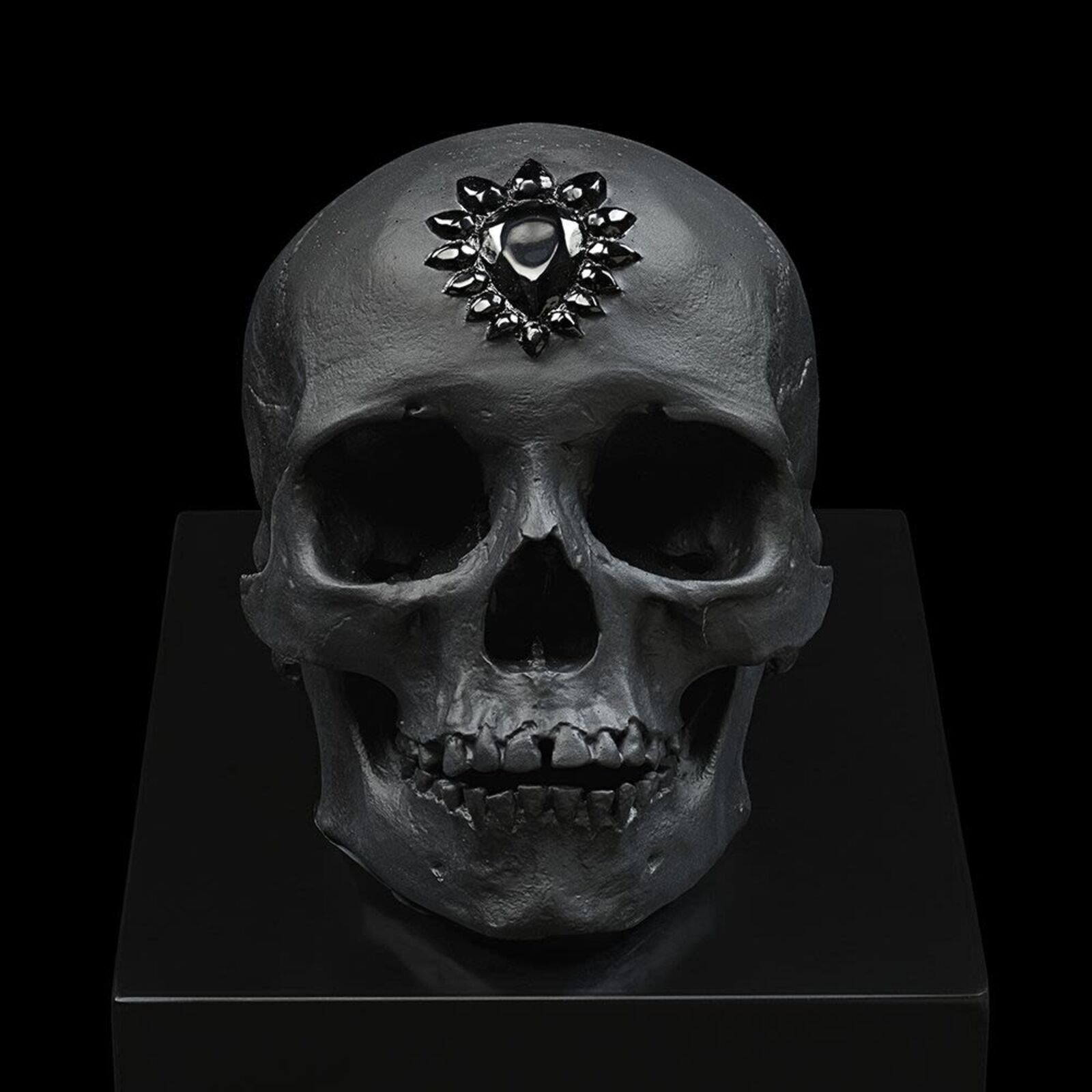 A skull with a black and white flower on it's head.