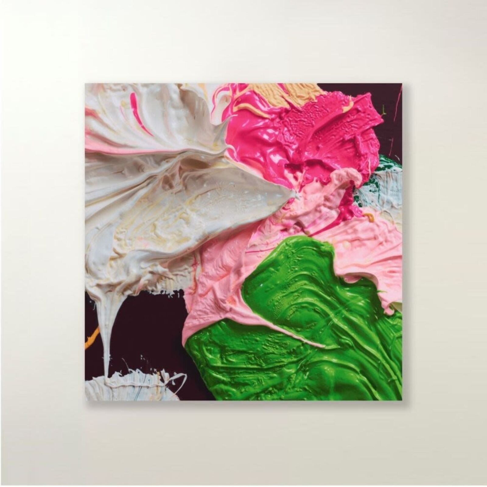 A close up of a painting with pink, green and white paint.