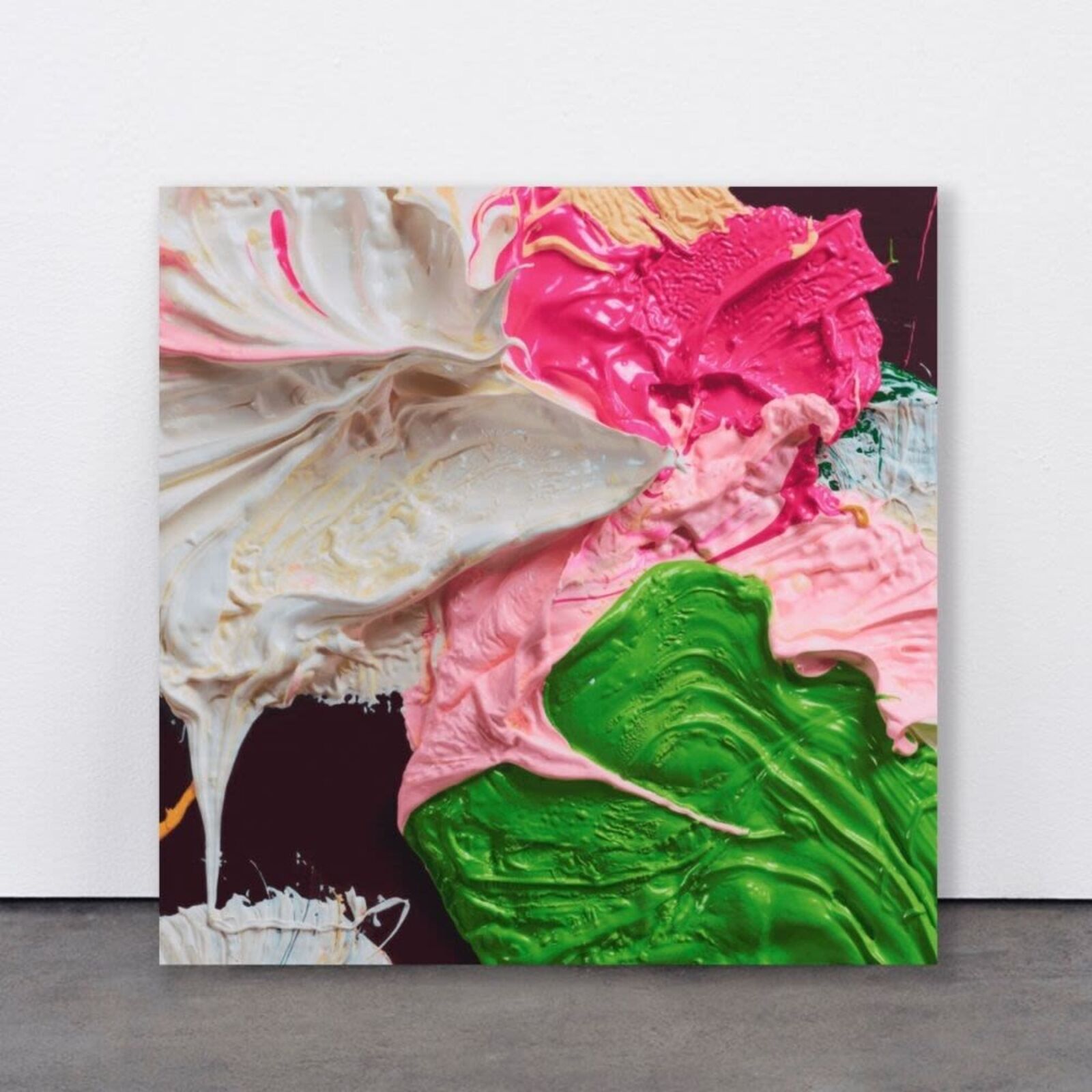 A close up of a painting with pink, green and white paint.