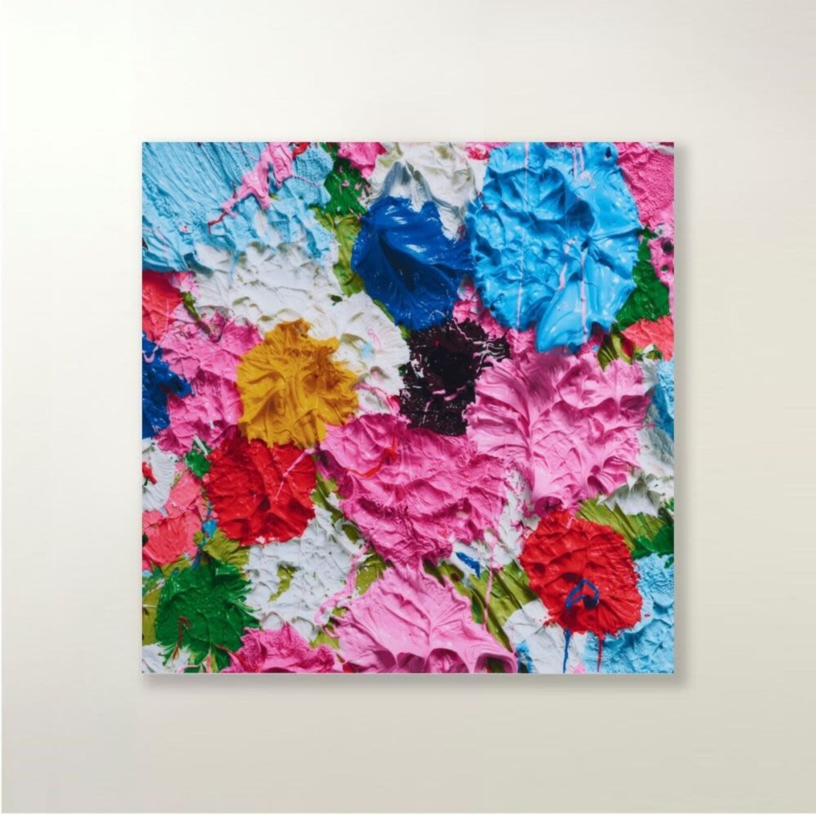A painting of colorful flowers on a white wall.