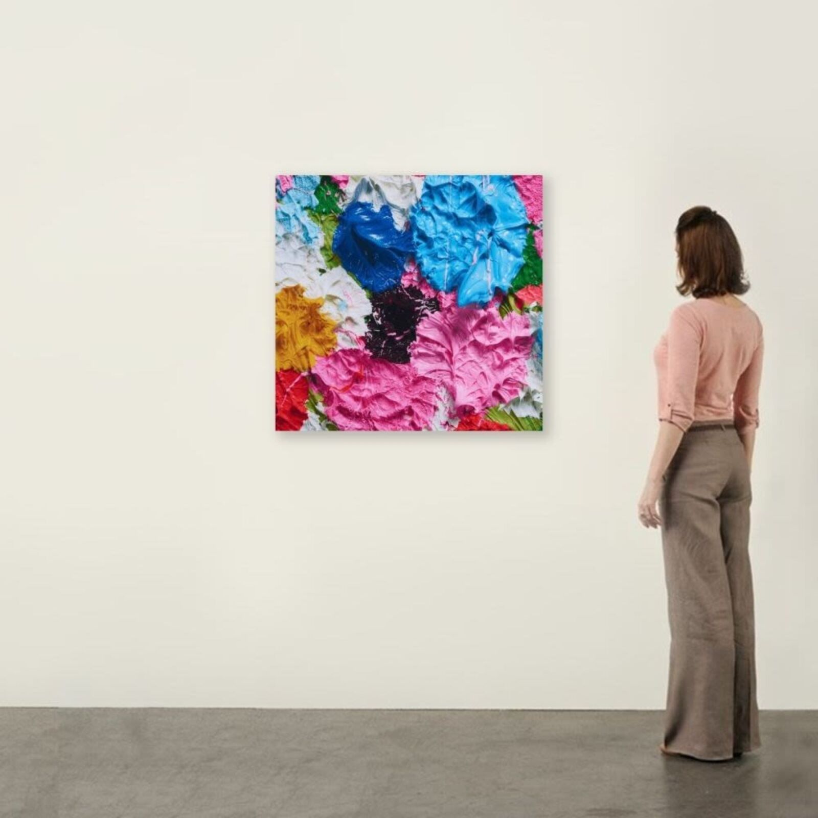 A painting of colorful flowers on a white wall.