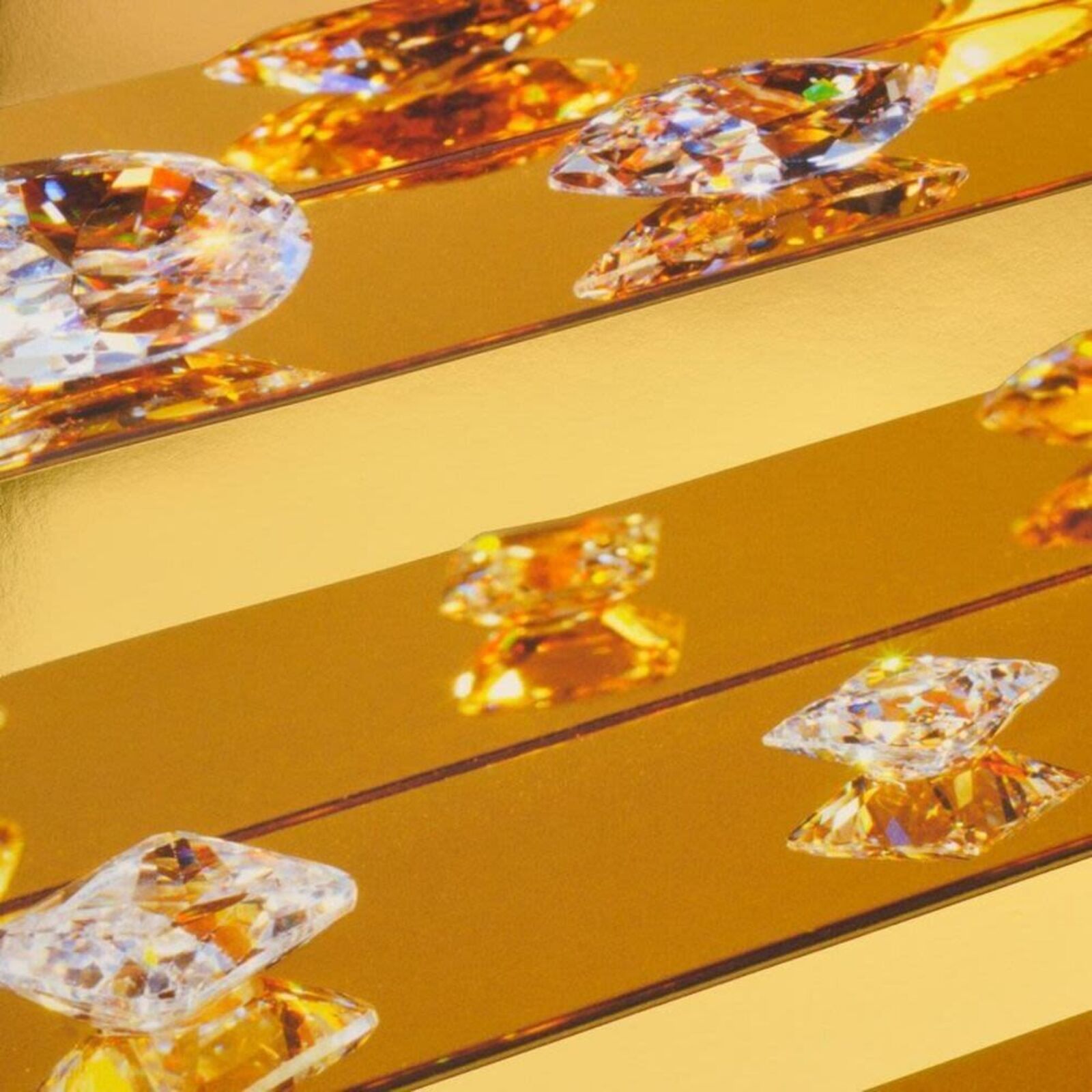 A picture of a gold and white striped wall with diamonds on it.