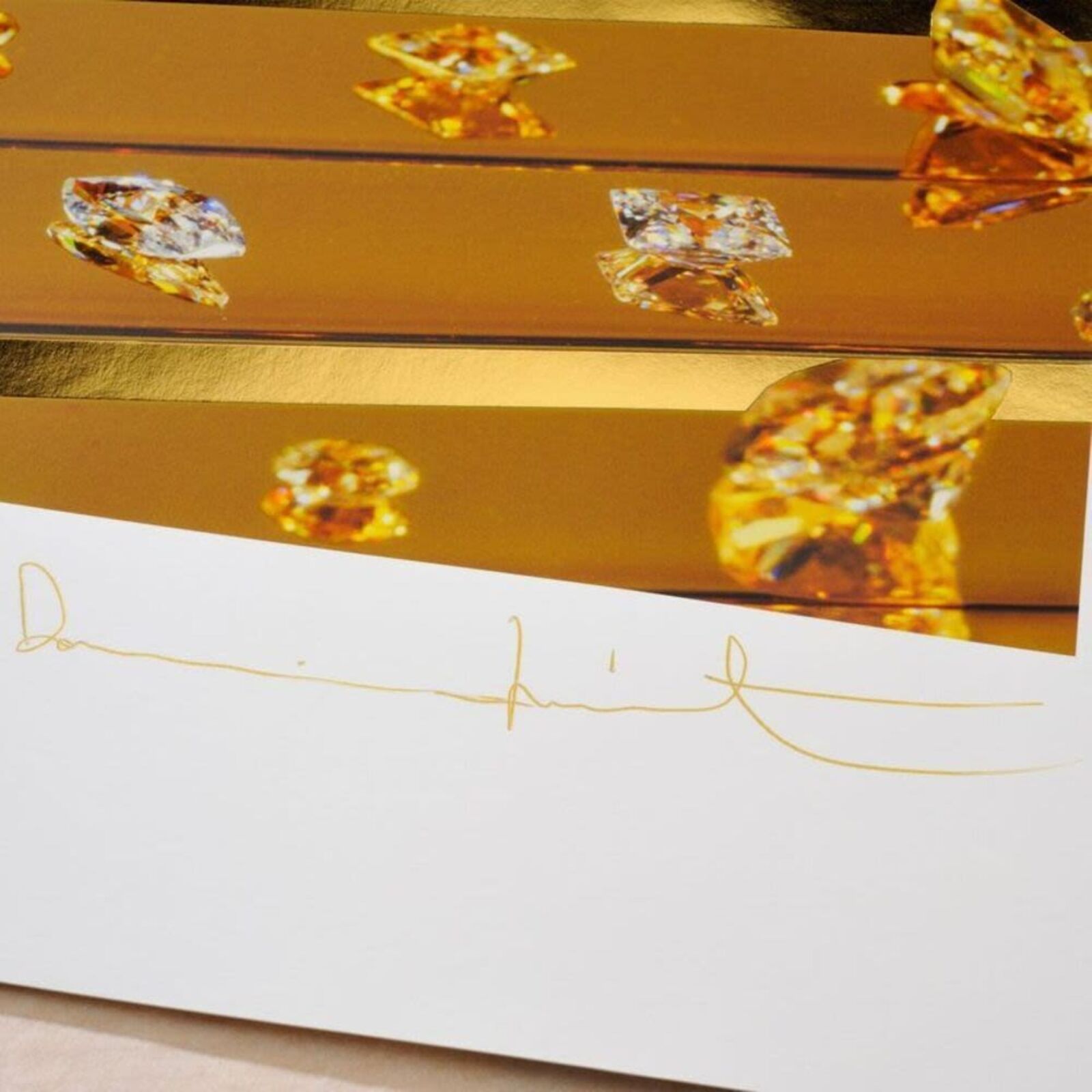 A picture of a gold and white striped wall with diamonds on it.