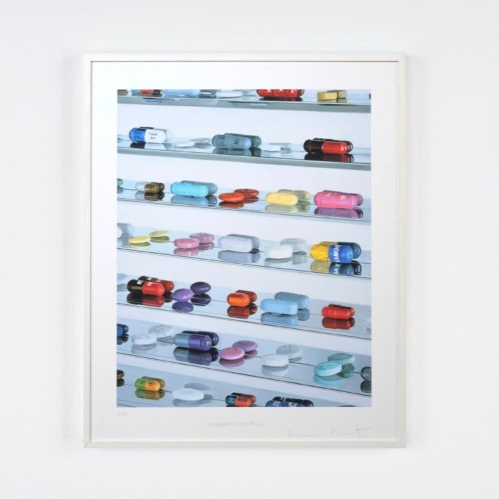 A picture of a shelf filled with lots of different colored pills.