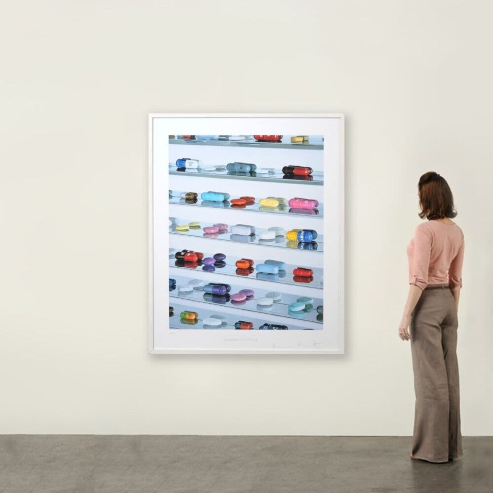 A picture of a shelf filled with lots of different colored pills.