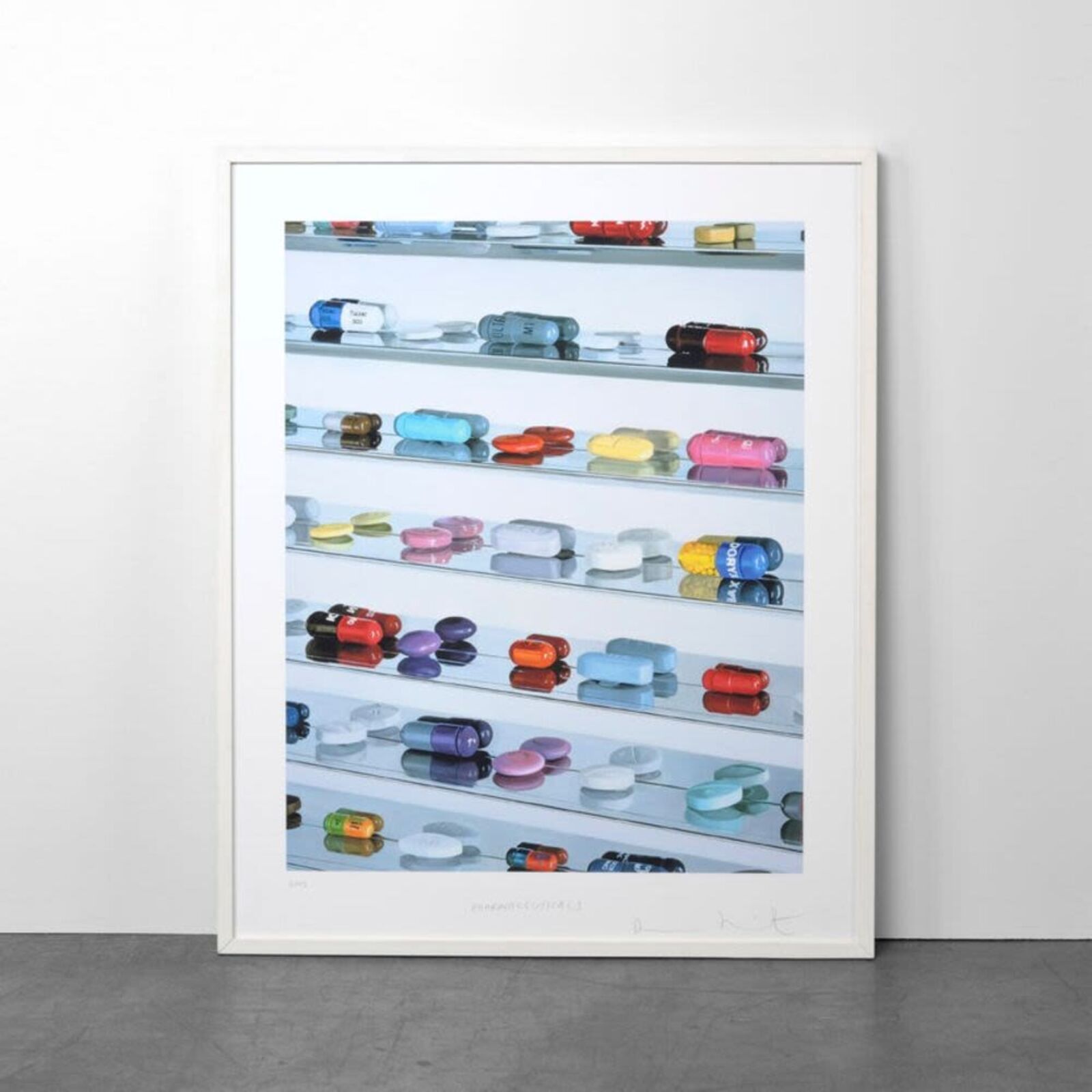 A picture of a shelf filled with lots of different colored pills.