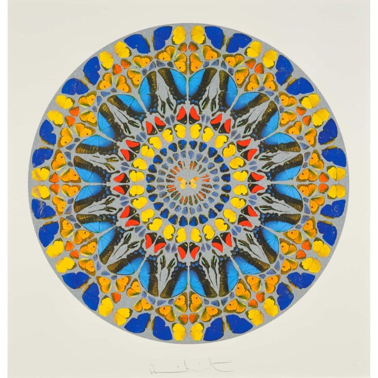 A blue and yellow mandala on a white wall in a room.