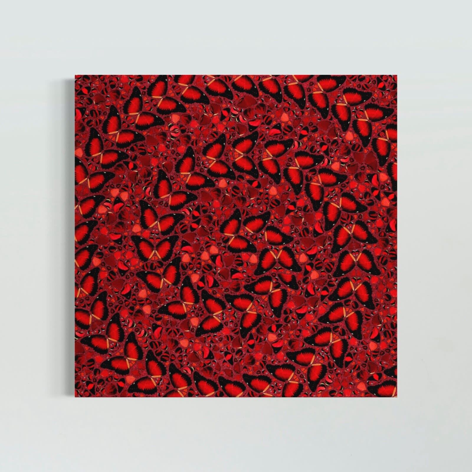 A wooden bench sitting in front of three red paintings on a white wall.