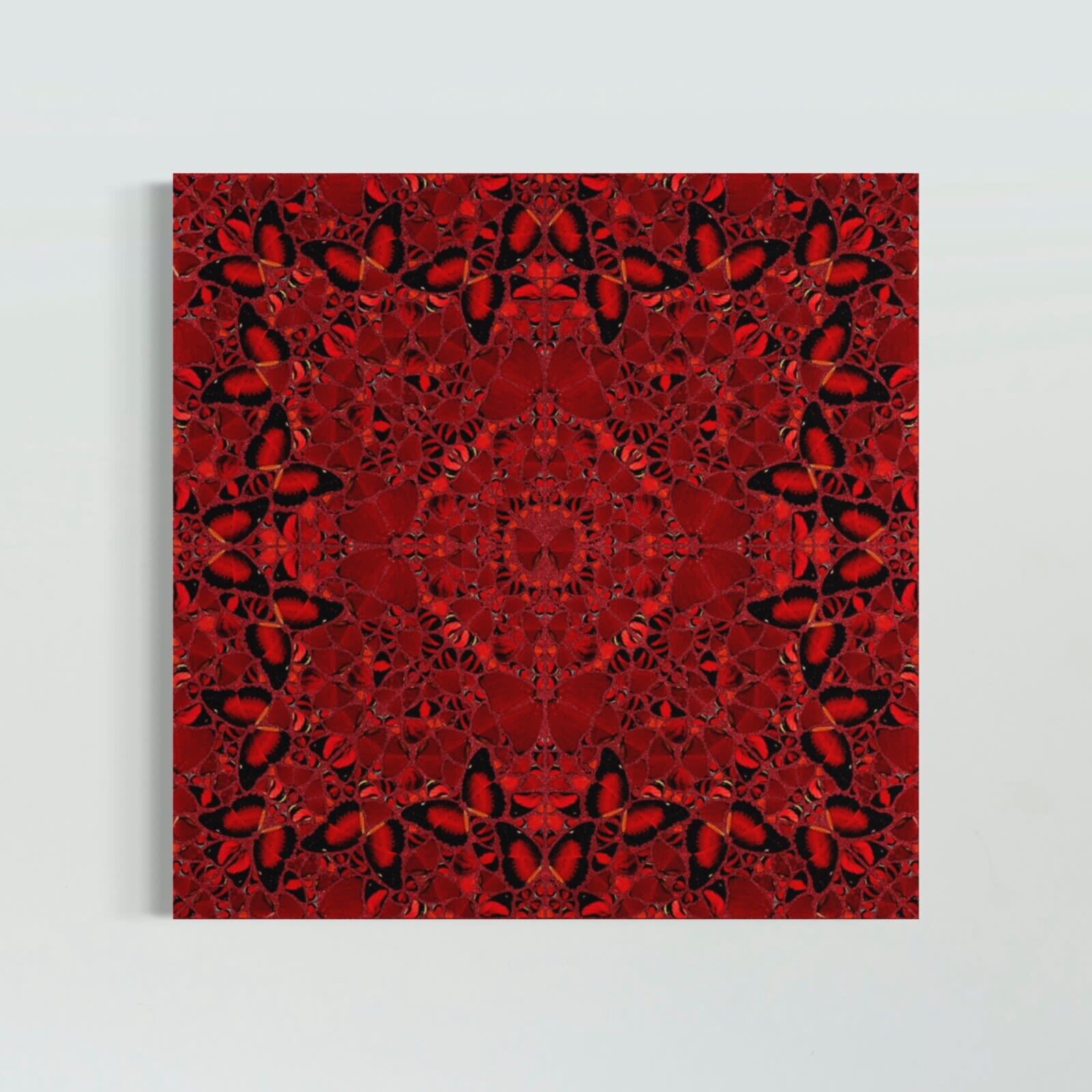 A wooden bench sitting in front of three red paintings on a white wall.