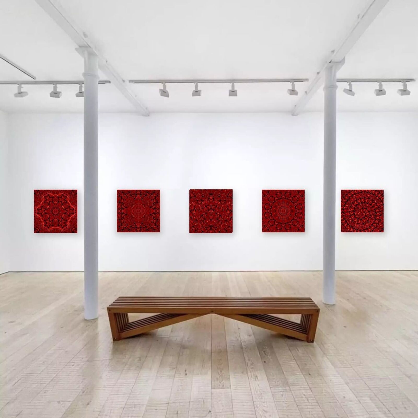 A wooden bench sitting in front of three red paintings on a white wall.