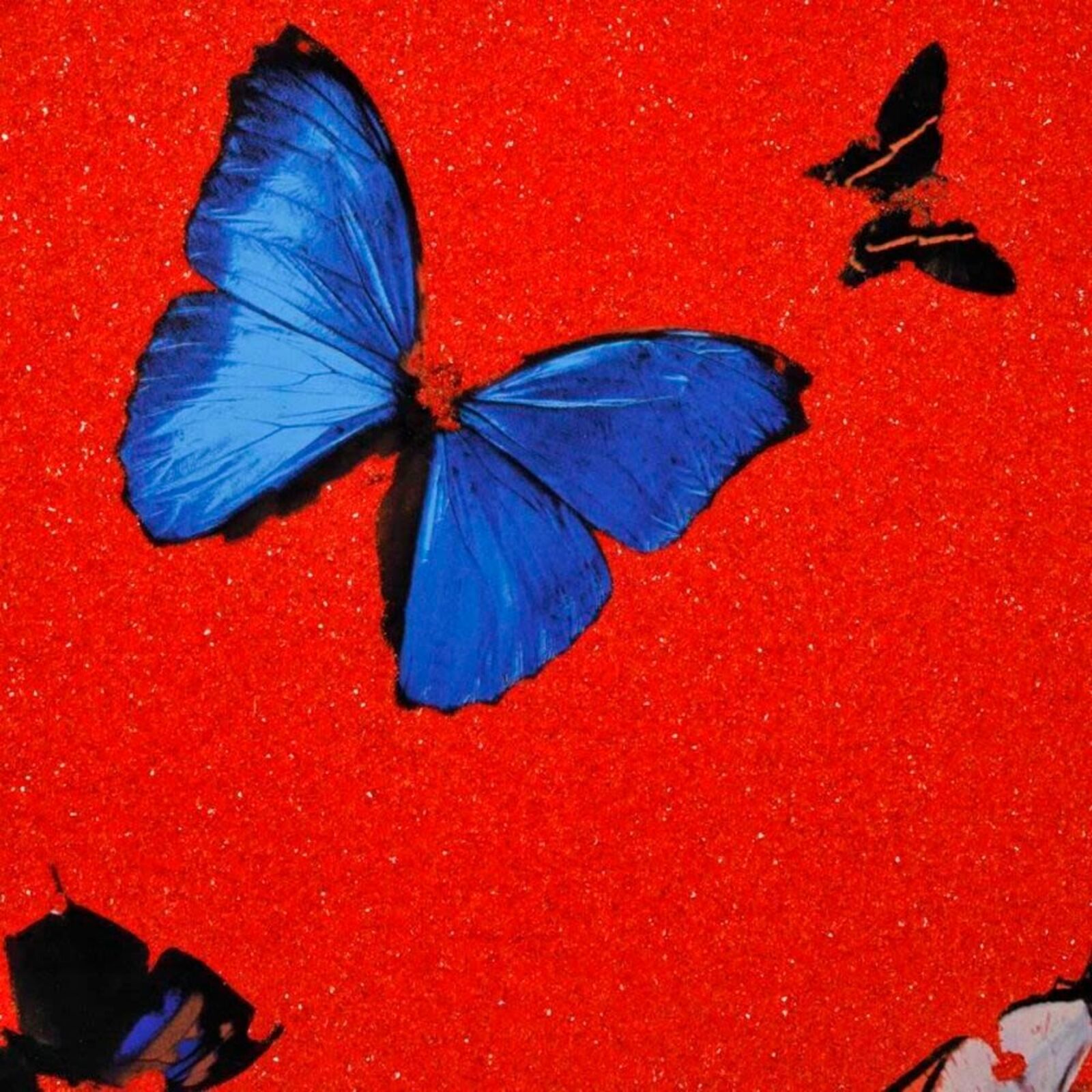 A red heart with butterflies flying around it.