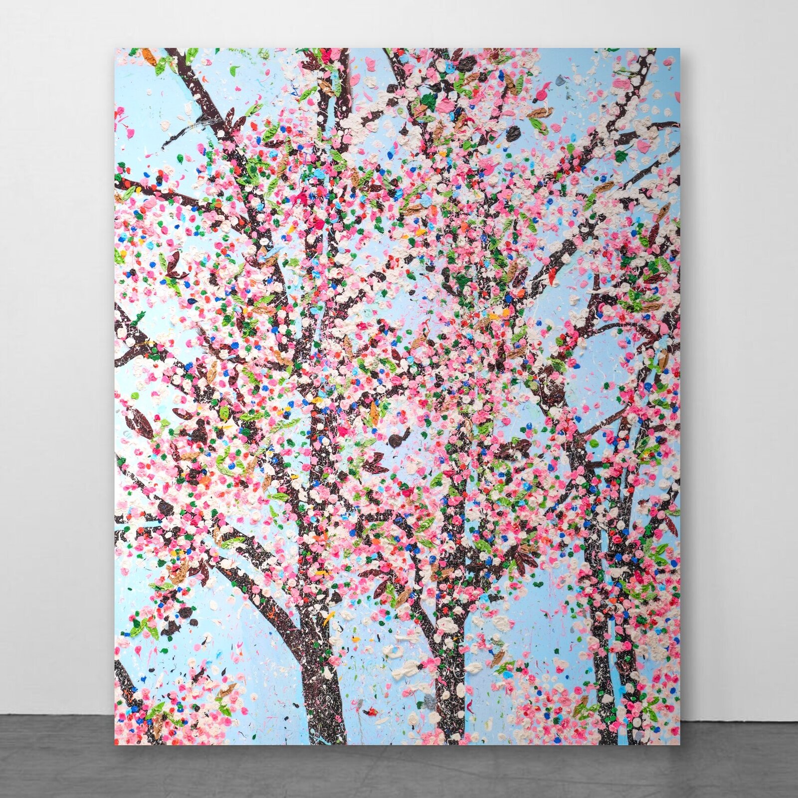 A colorful, textured painting of blooming trees against a light blue sky.