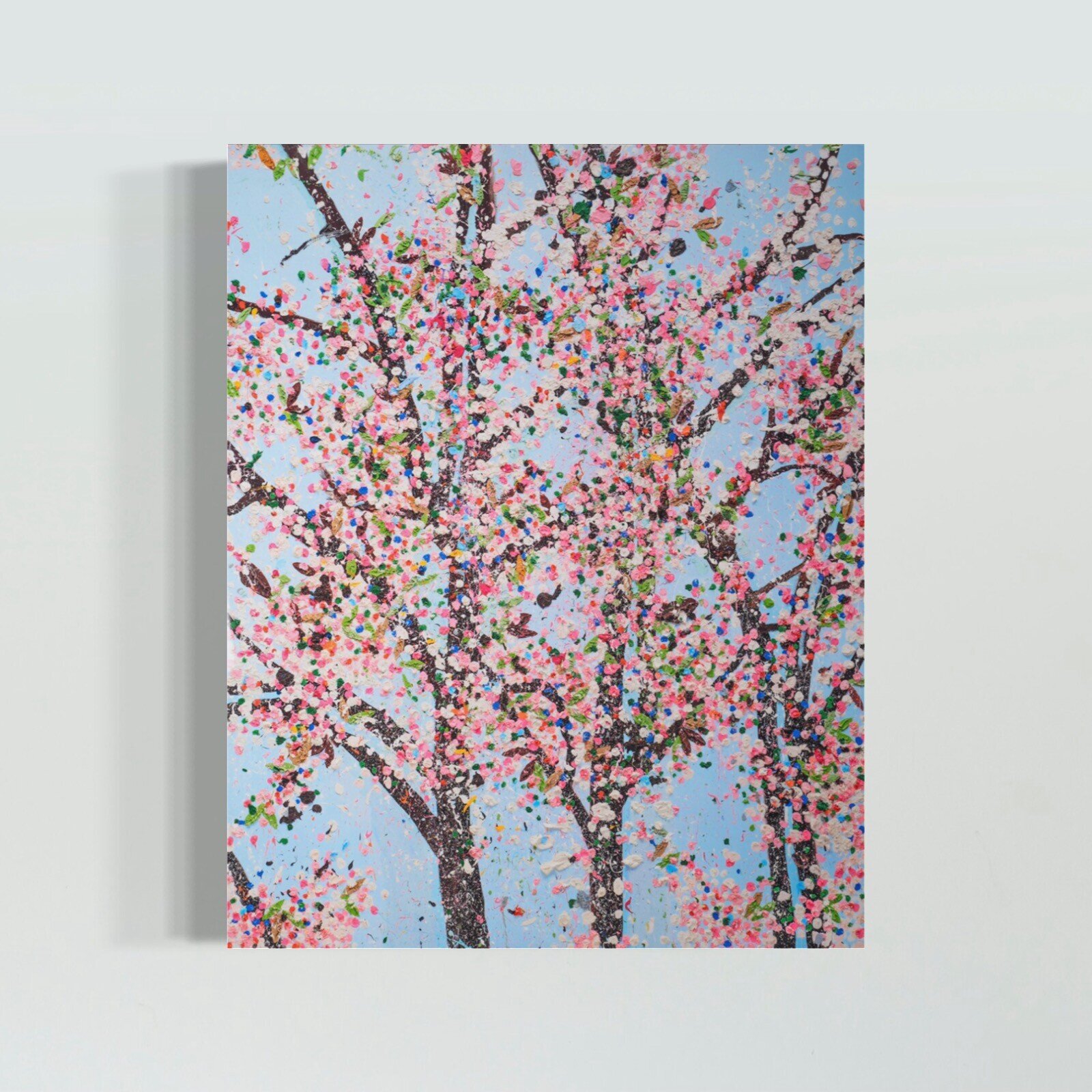 A colorful, textured painting of blooming trees against a light blue sky.