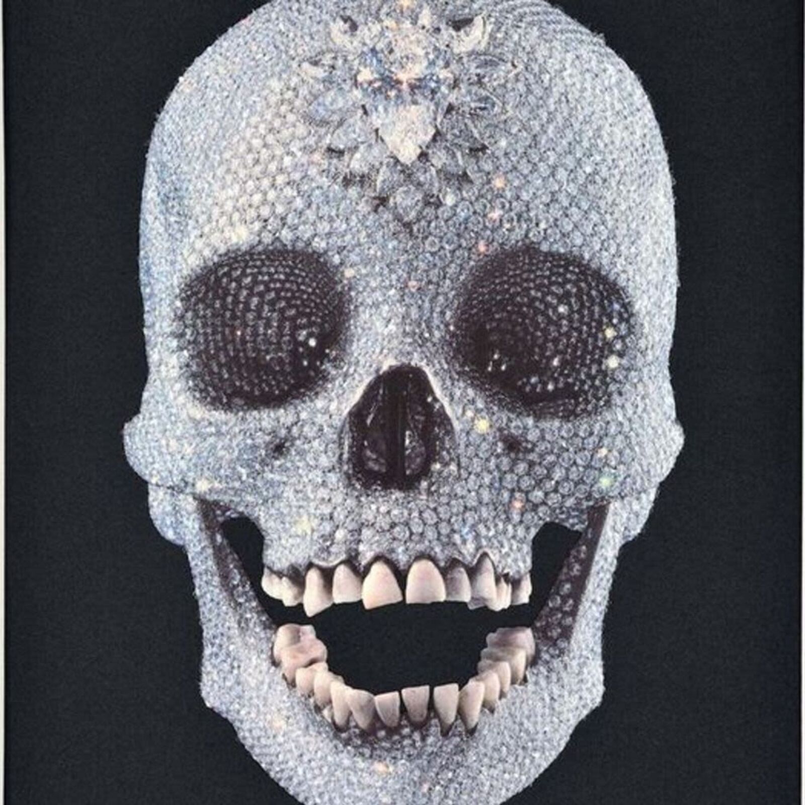 A framed picture of a skull with a diamond on it.