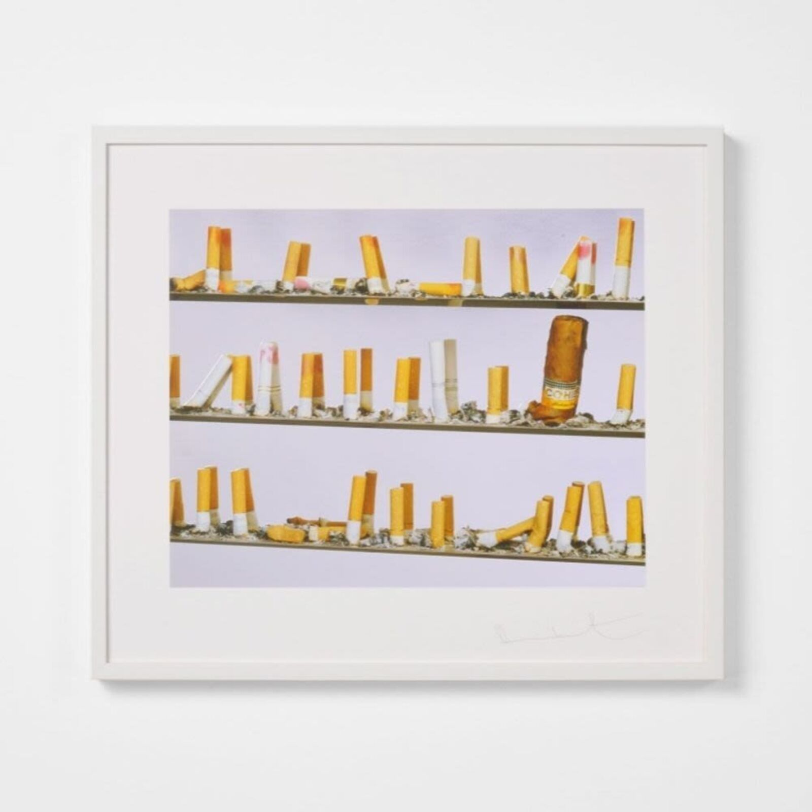 A picture of a shelf of cigarettes on a wall.