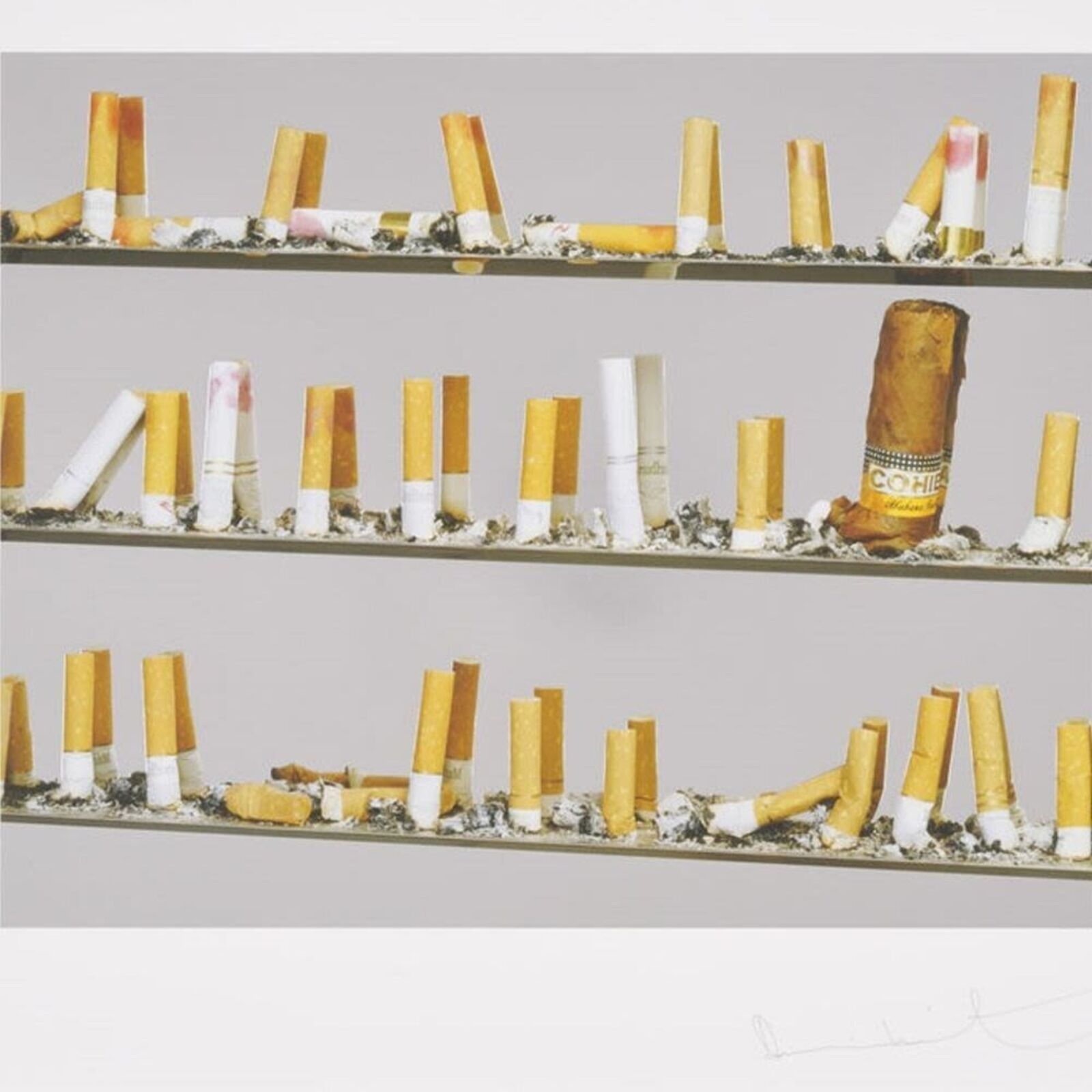 A picture of a shelf of cigarettes on a wall.