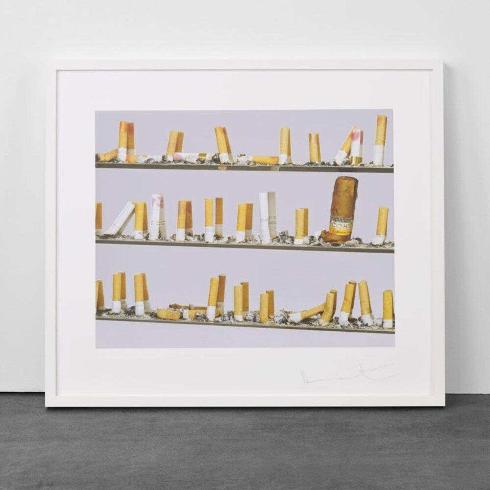 A picture of a shelf of cigarettes on a wall.