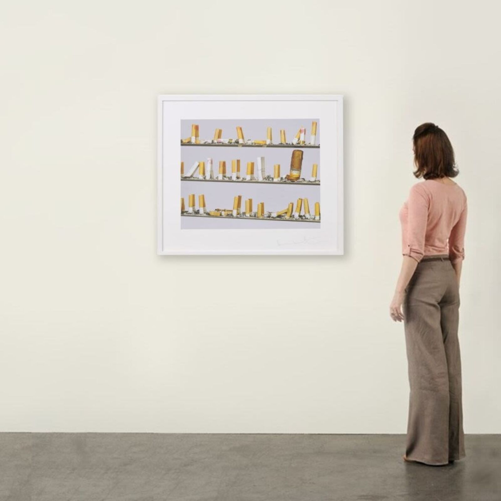 A picture of a shelf of cigarettes on a wall.
