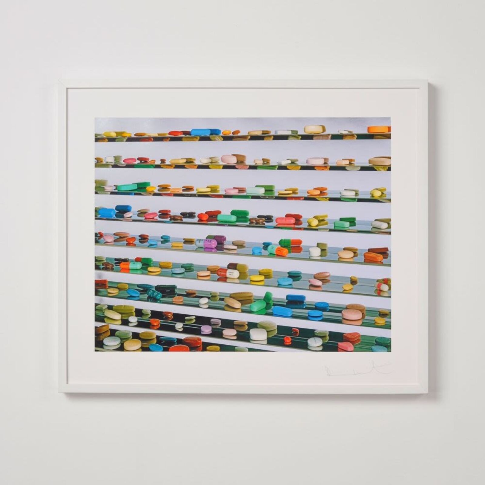 A picture of a white frame hanging on a wall.