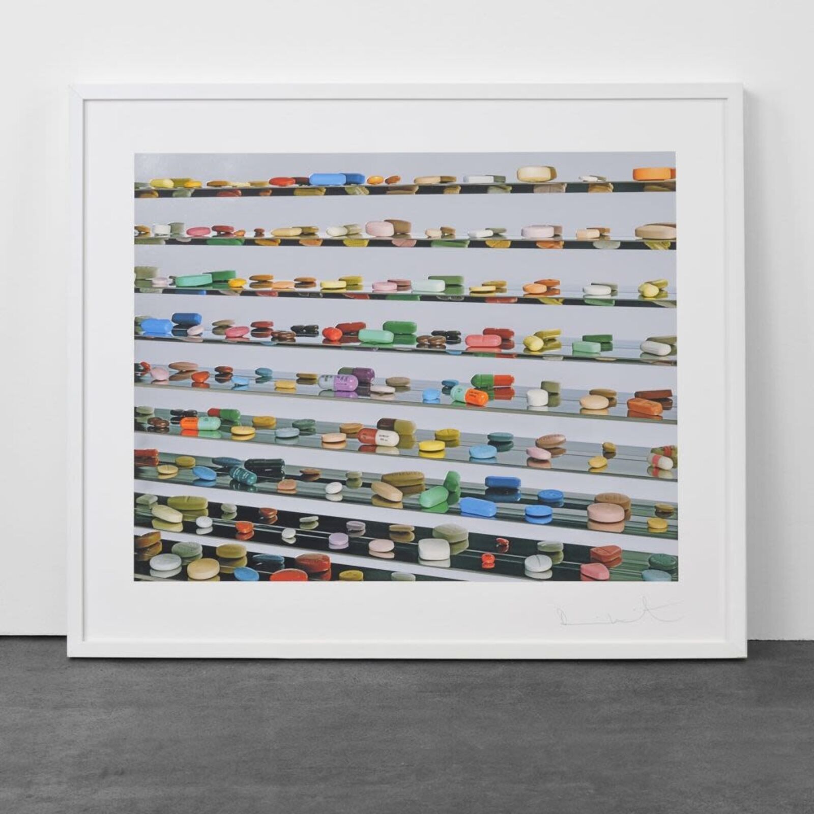 A picture of a white frame hanging on a wall.