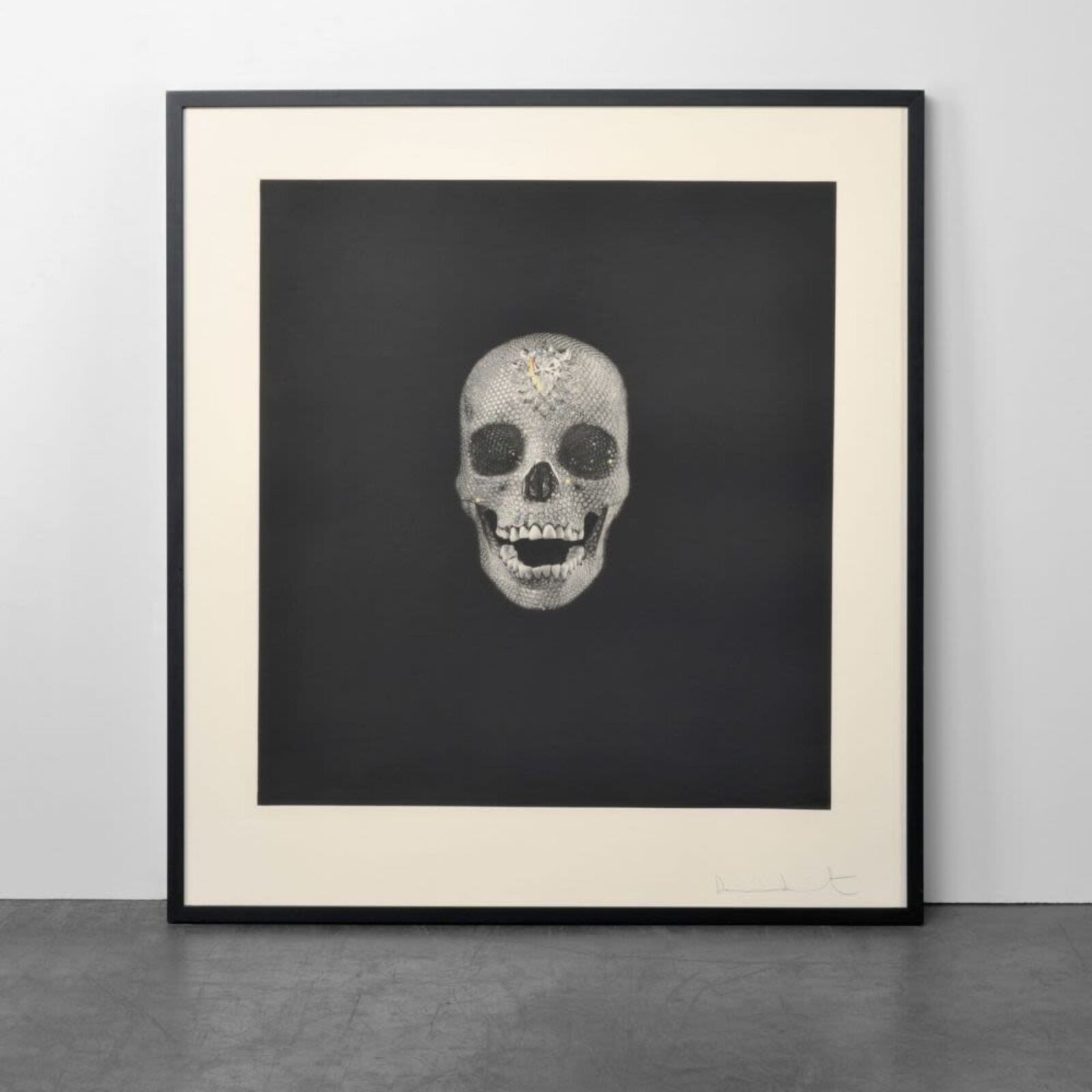 A black and white drawing of a skull on a wall.