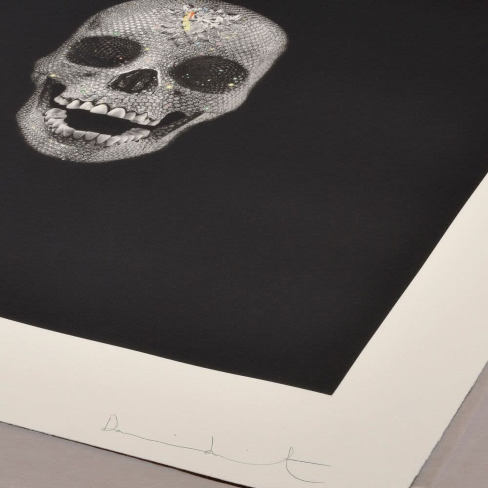 A black and white drawing of a skull on a wall.