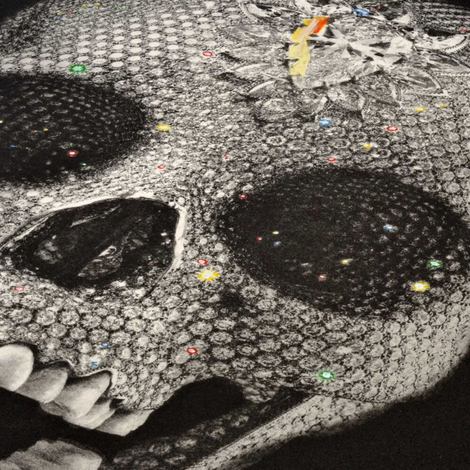 A black and white drawing of a skull on a wall.