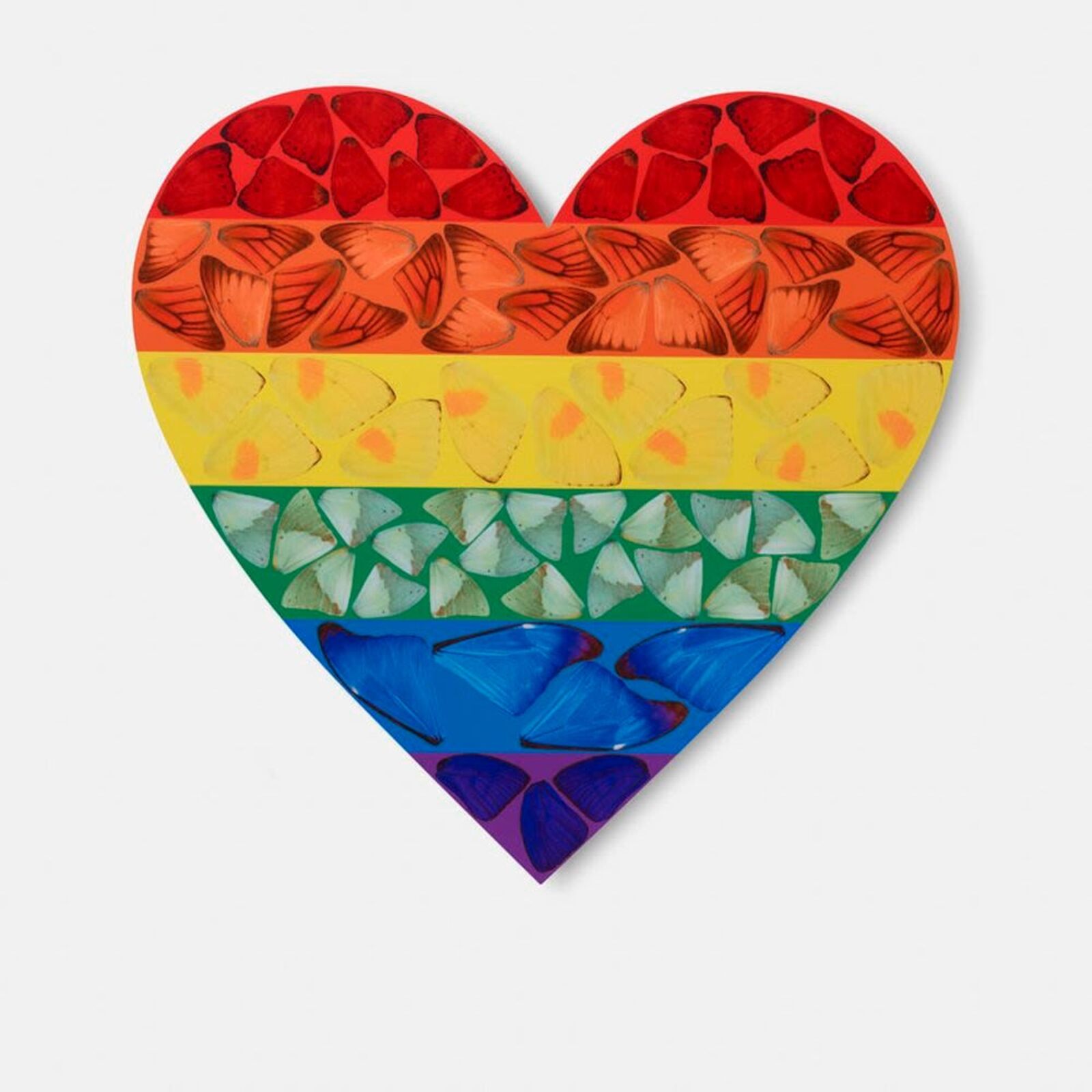 A rainbow colored heart shaped piece of art on a white background.