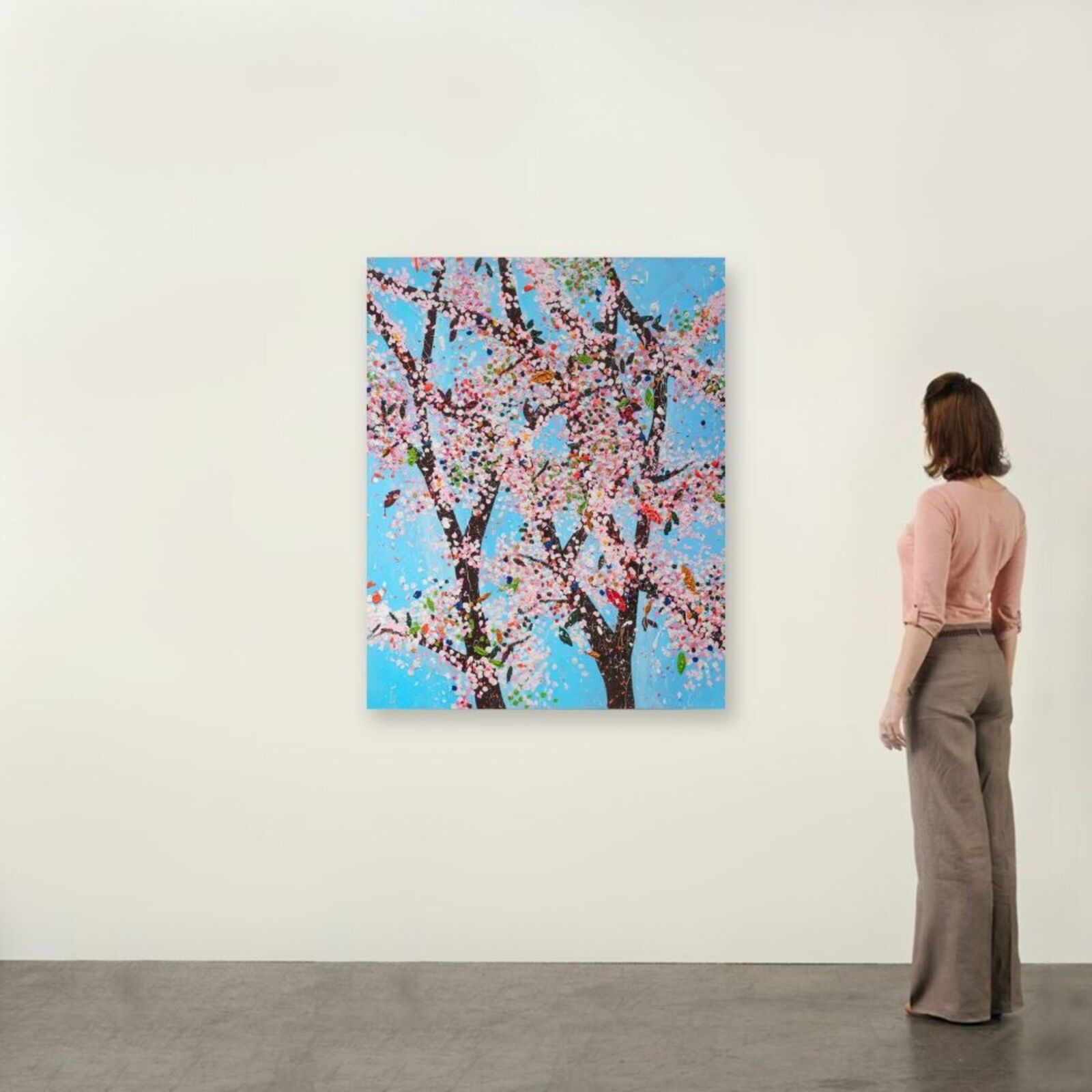 A living room filled with furniture and a large painting.