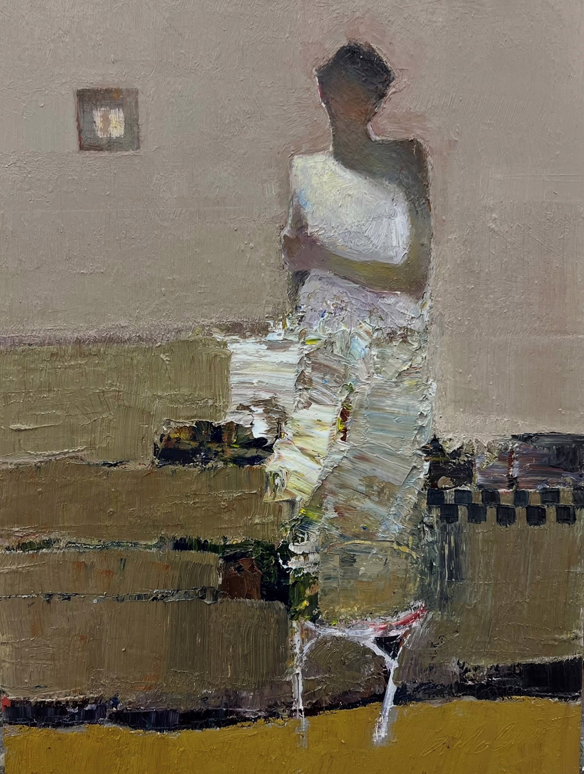 A figure stands in a room with a checkered tablecloth and a framed picture on the wall.