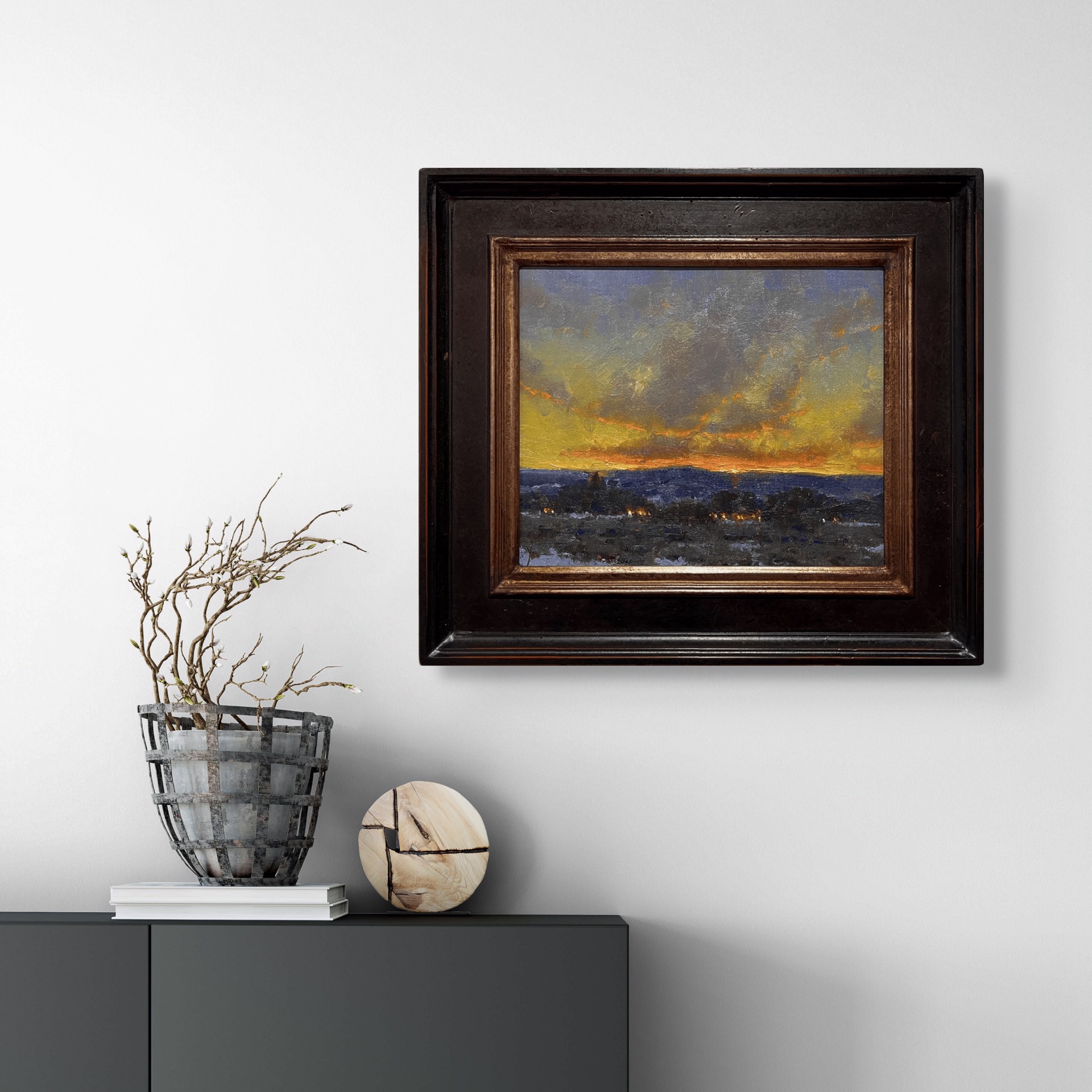 A dramatic landscape painting capturing a twilight sky over a dark, snowy foreground.