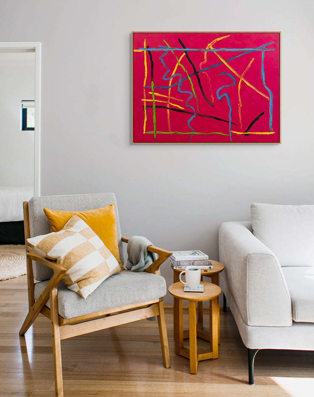 A red painting with blue, yellow, and red lines on it.