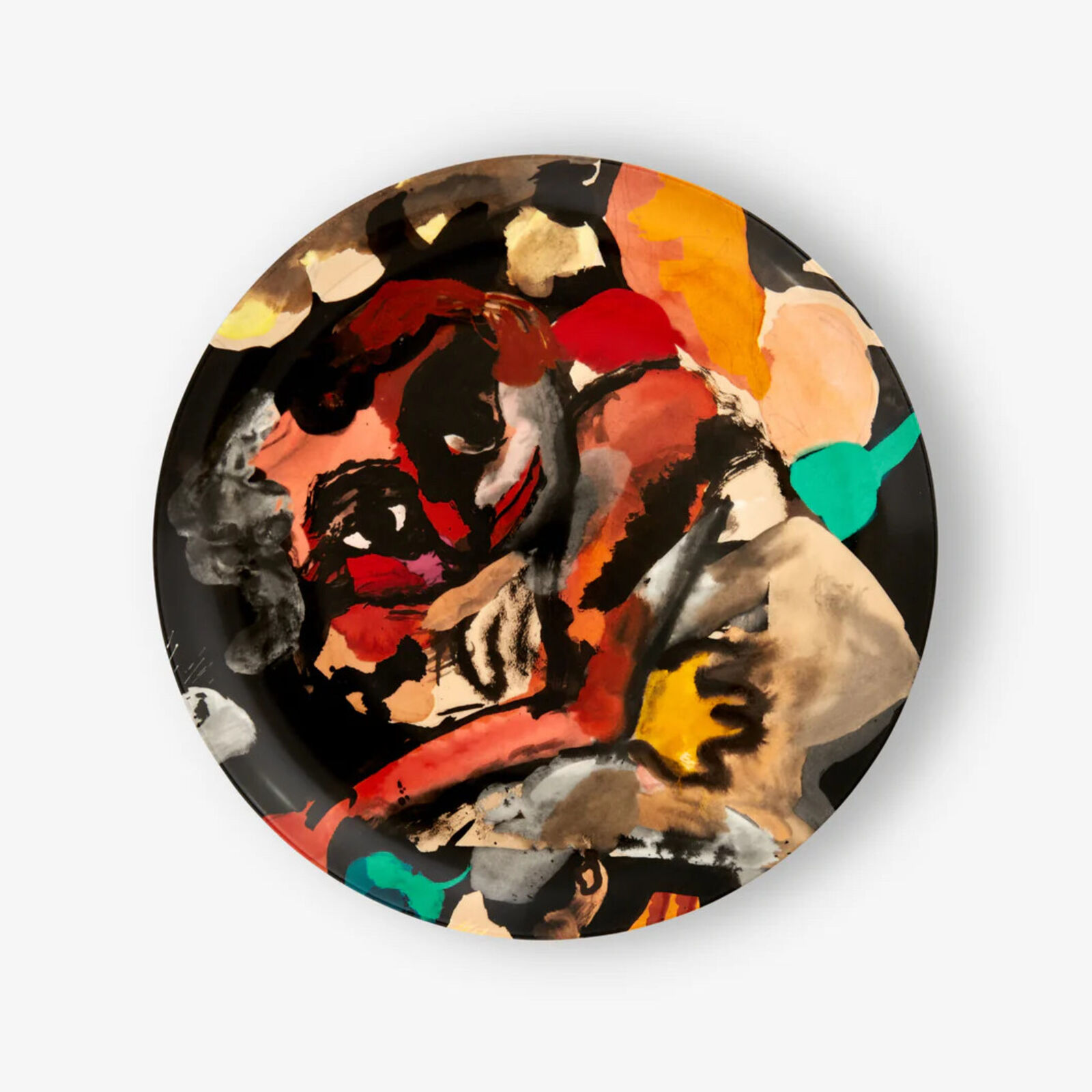 A plate with a painting of a woman's face on it.