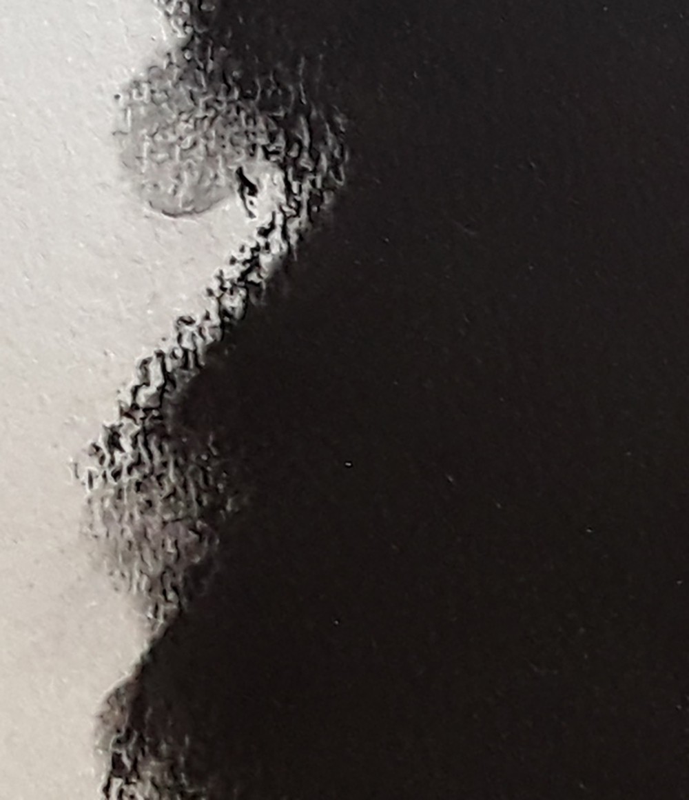 a close up of a black and white image of a person's face