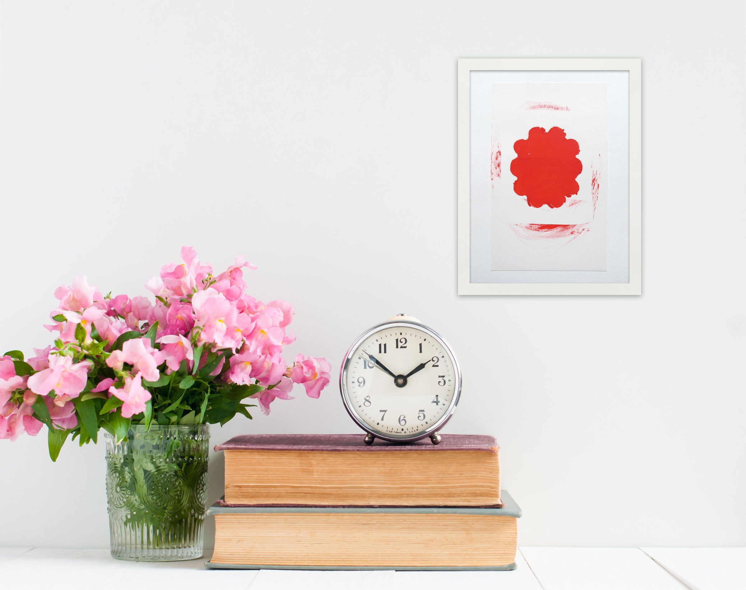 A red and white painting on a white wall.