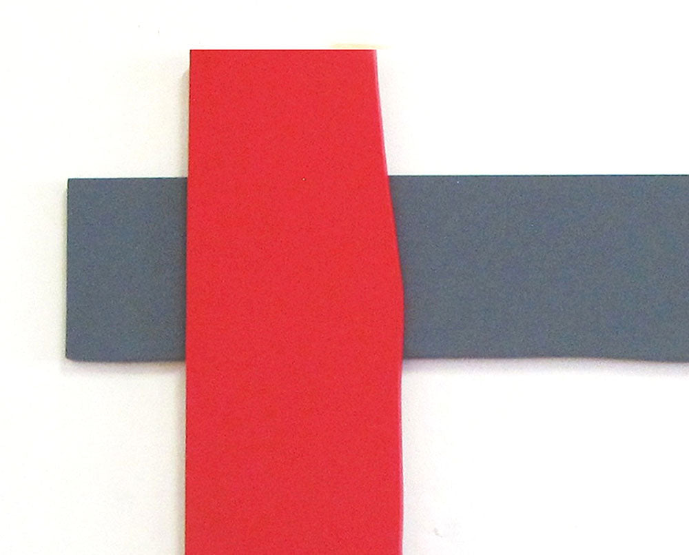 A picture frame with red and gray strips of tape on it.