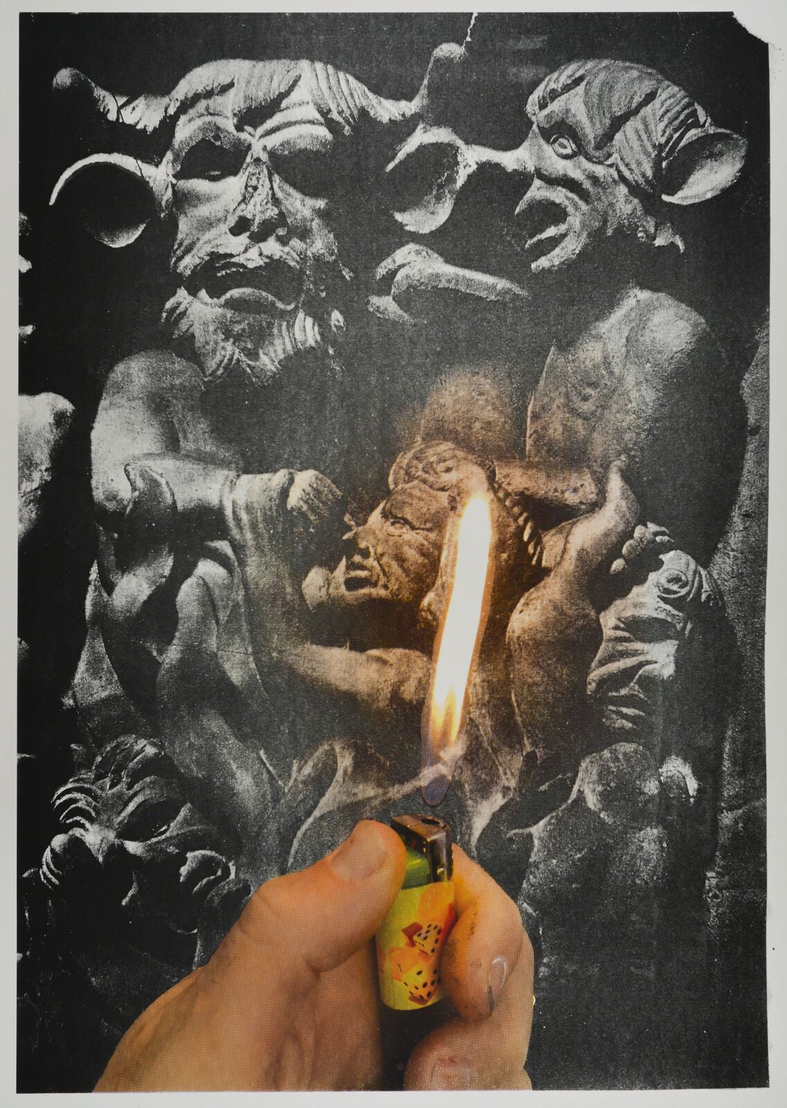 A person holding a lighter in front of a black and white image.