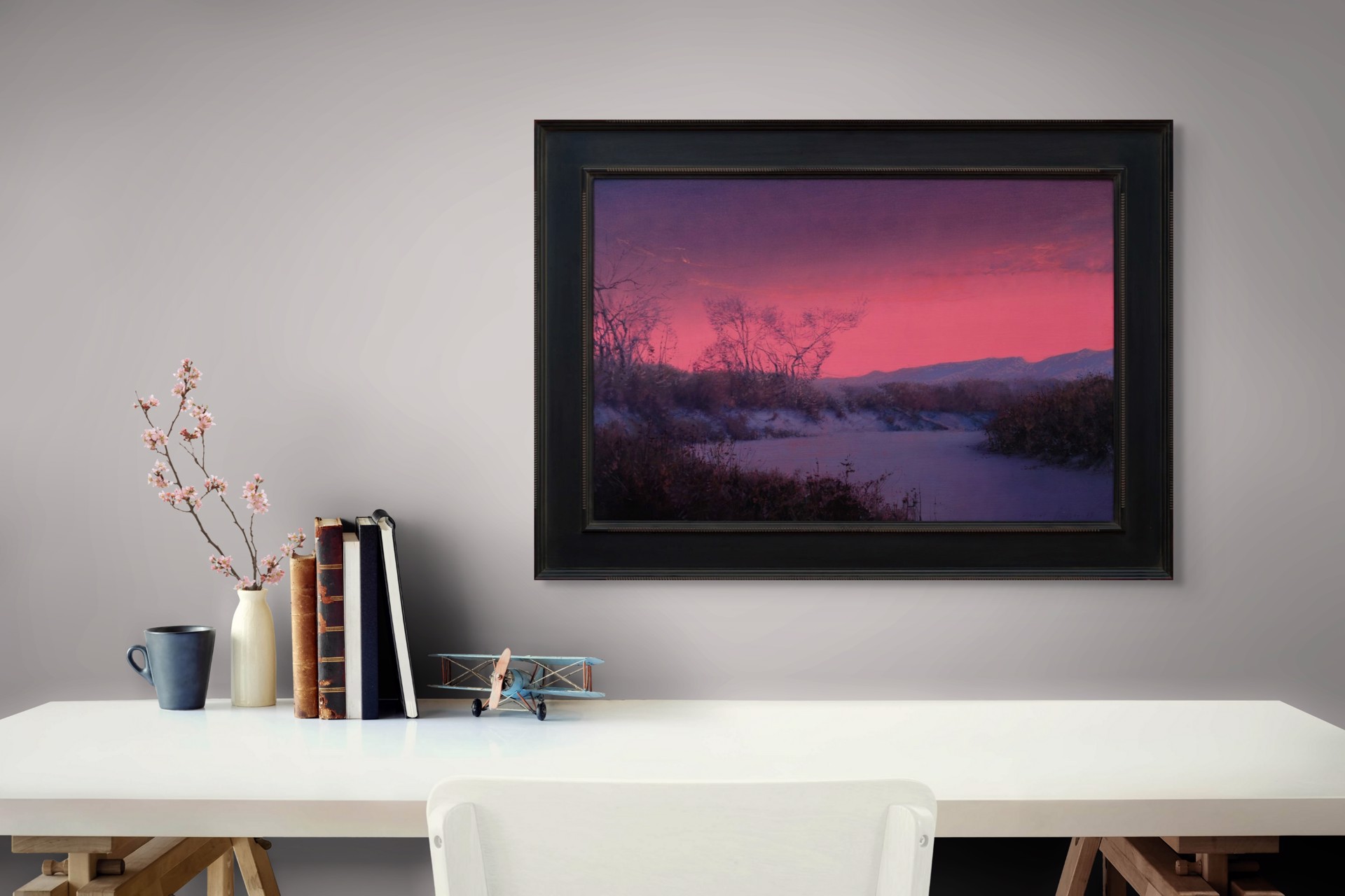 A winter landscape bathed in an intense pink and purple twilight glow.