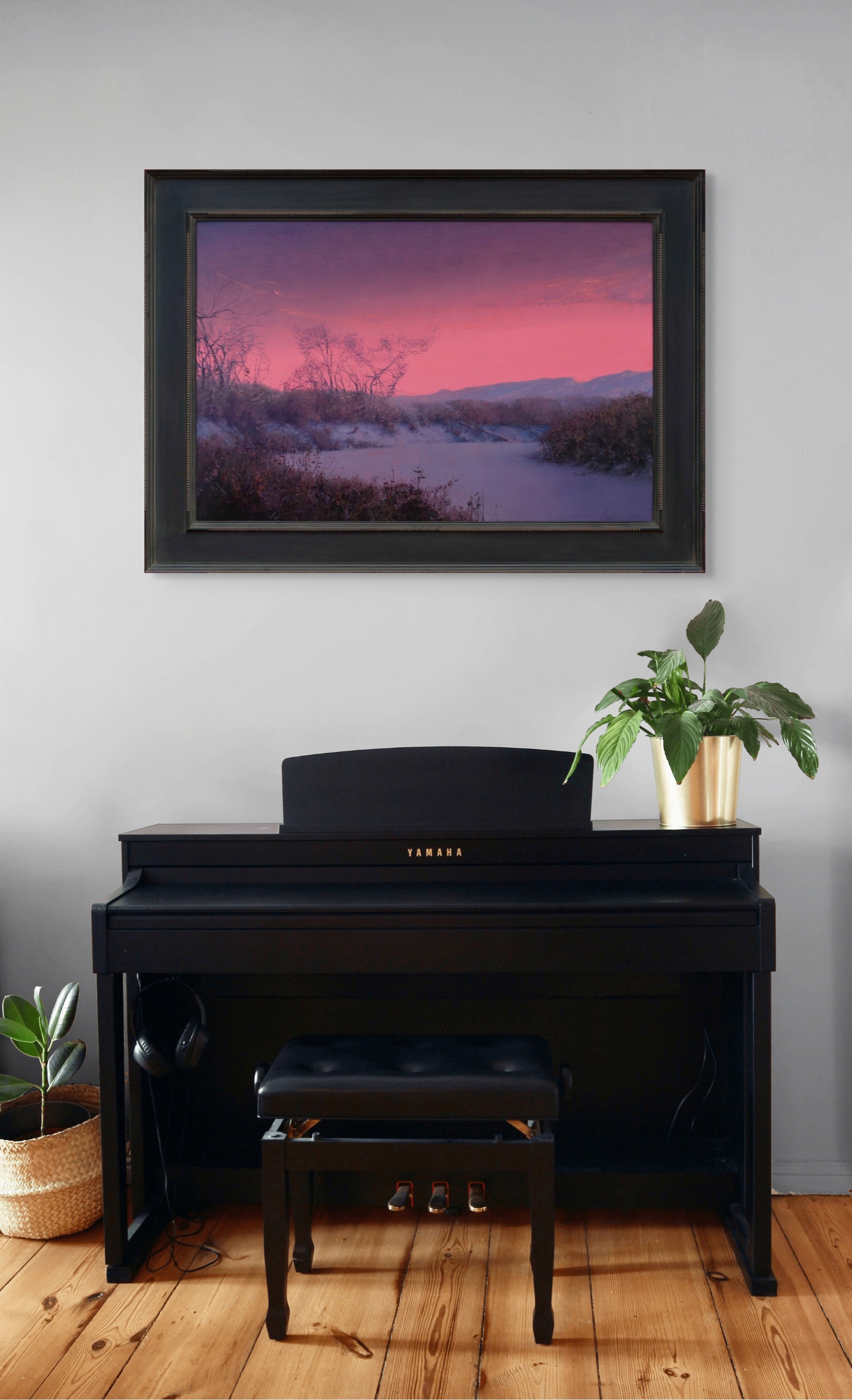 A winter landscape bathed in an intense pink and purple twilight glow.