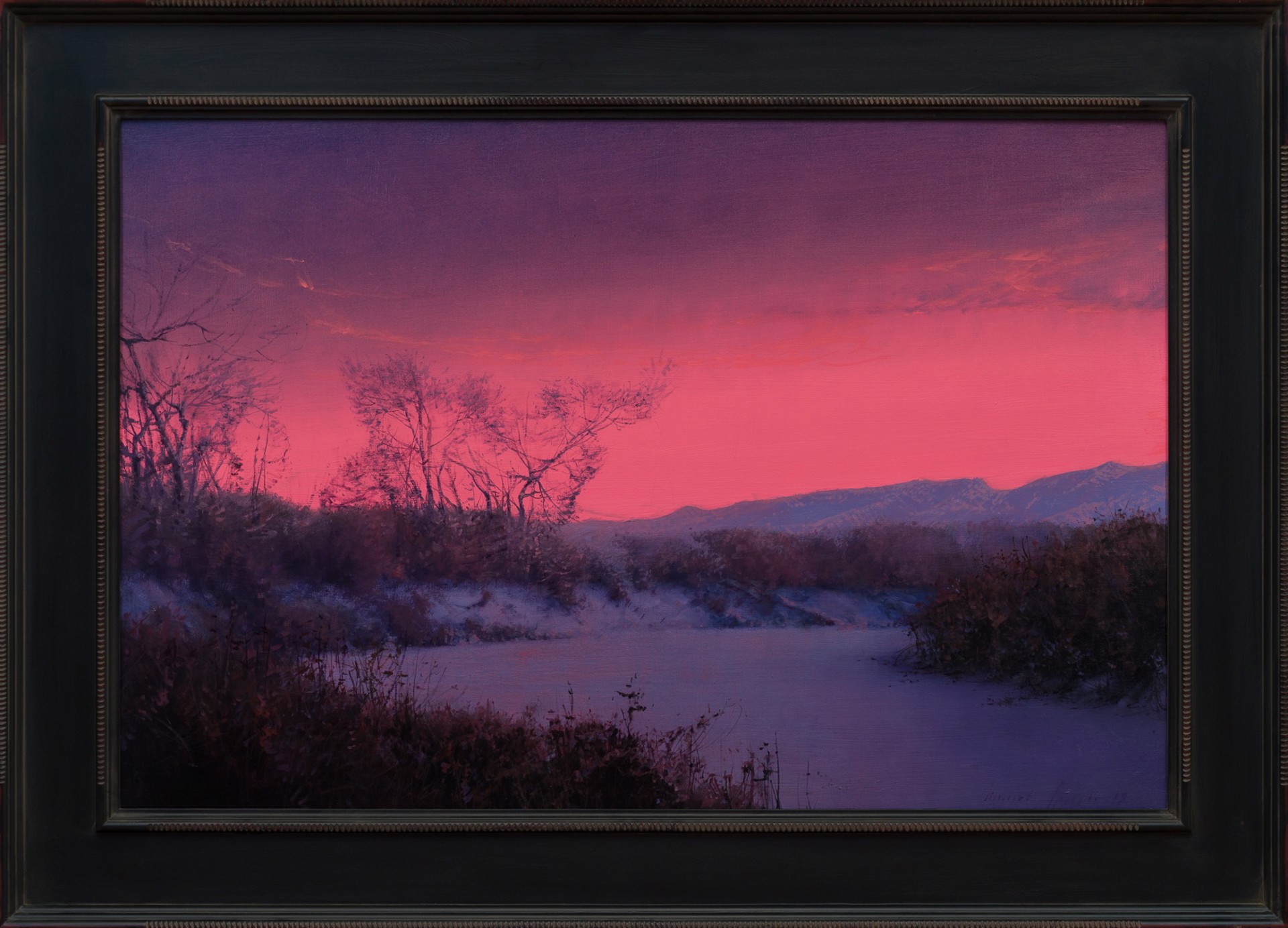 A winter landscape bathed in an intense pink and purple twilight glow.