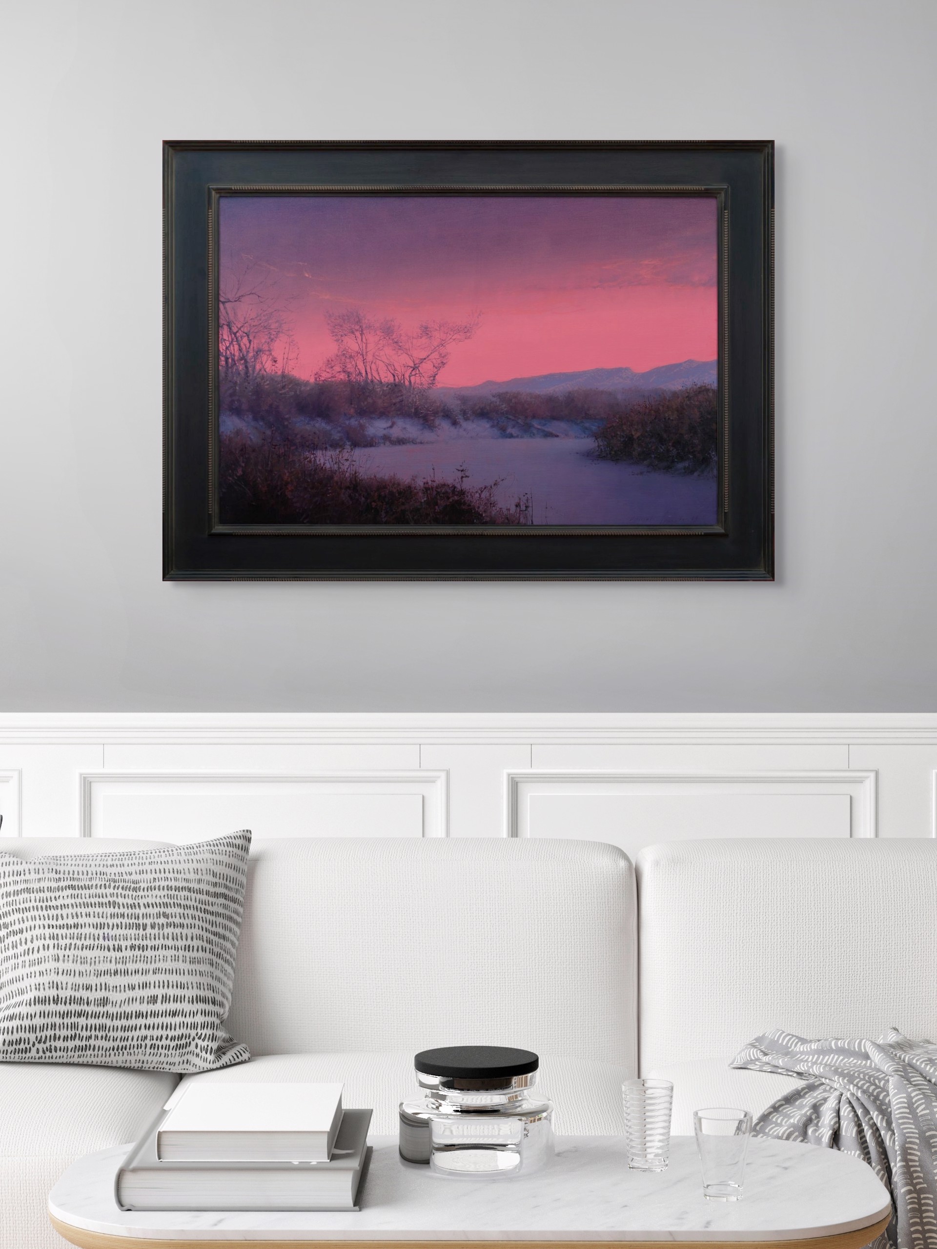 A winter landscape bathed in an intense pink and purple twilight glow.