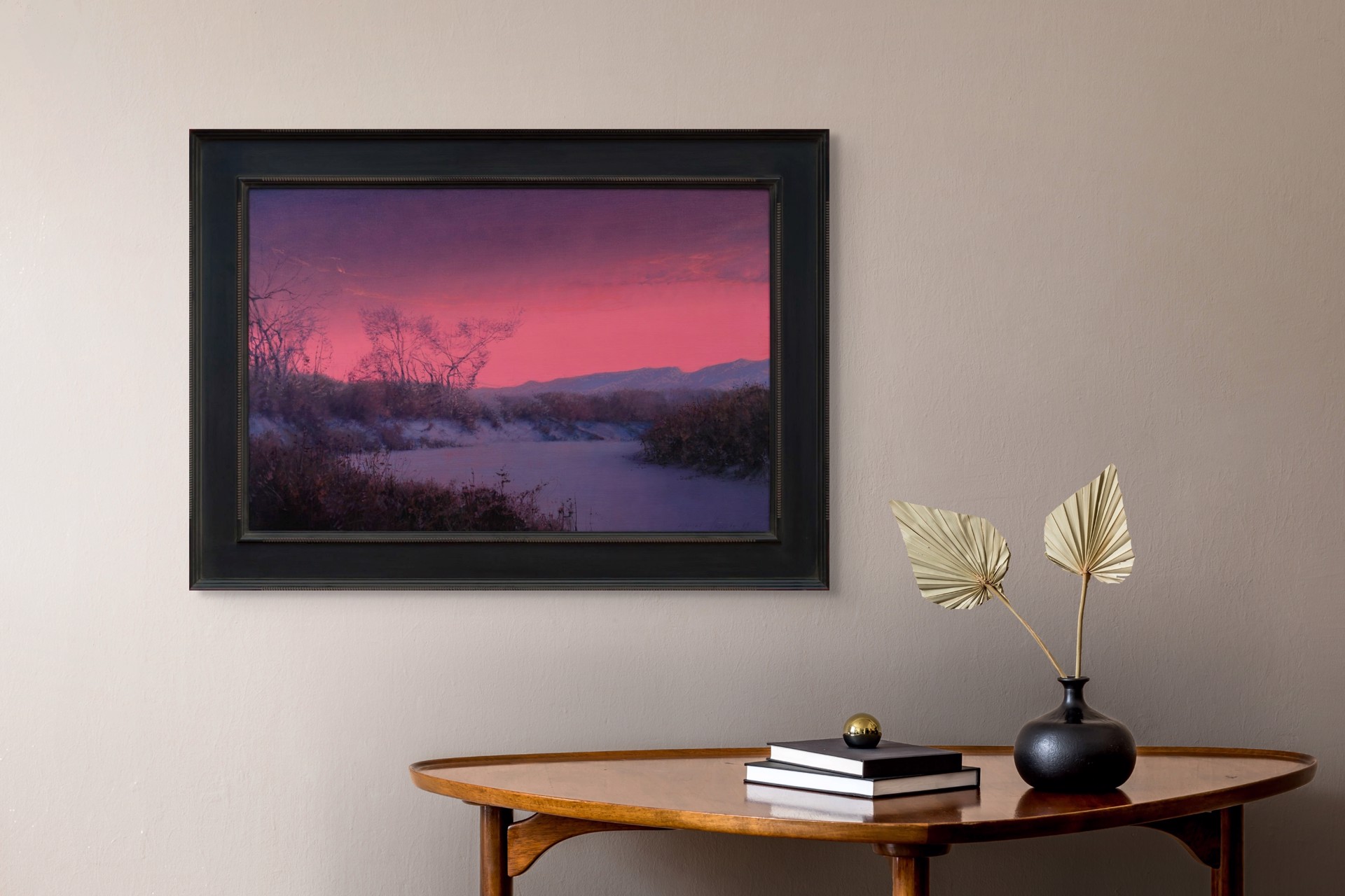 A winter landscape bathed in an intense pink and purple twilight glow.