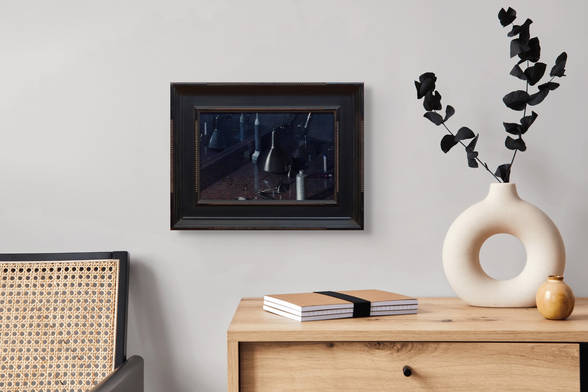 A dark, moody still life featuring metallic funnels and paint tubes on a reflective surface.