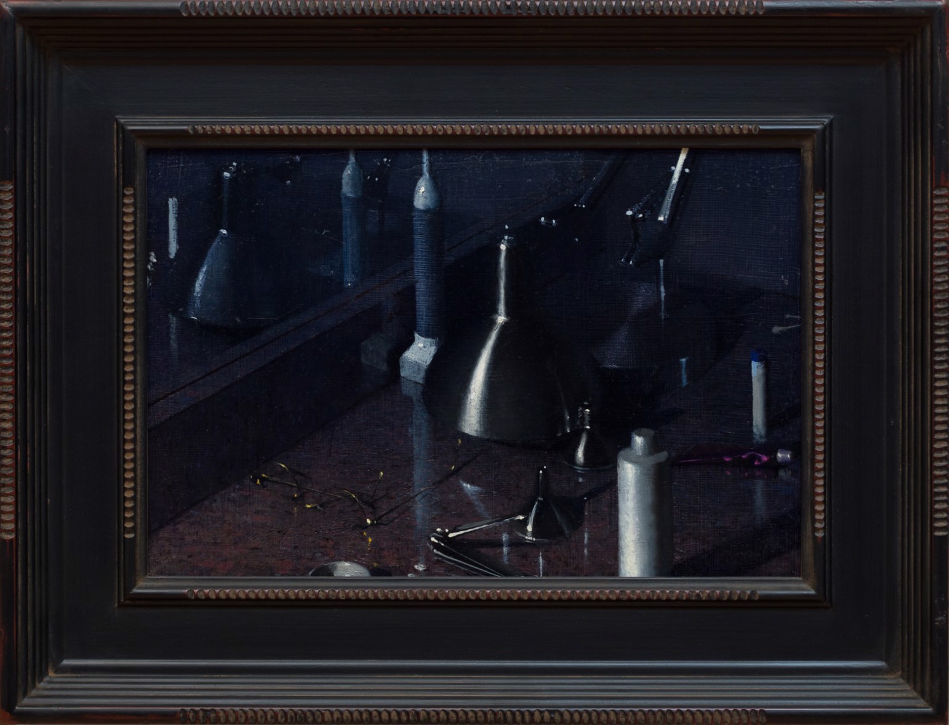 A dark, moody still life featuring metallic funnels and paint tubes on a reflective surface.