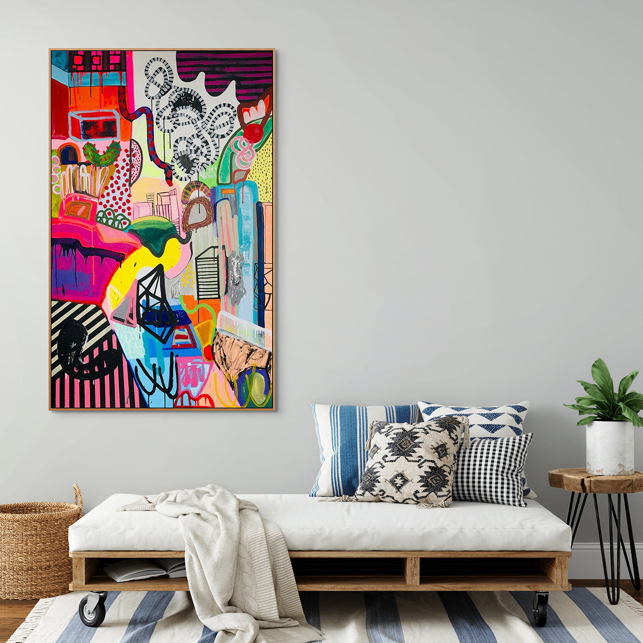 A colorful painting on a white wall in a room.