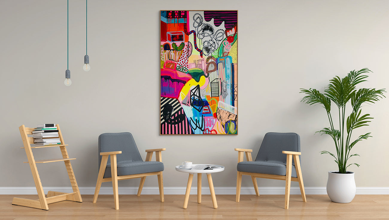 A colorful painting on a white wall in a room.